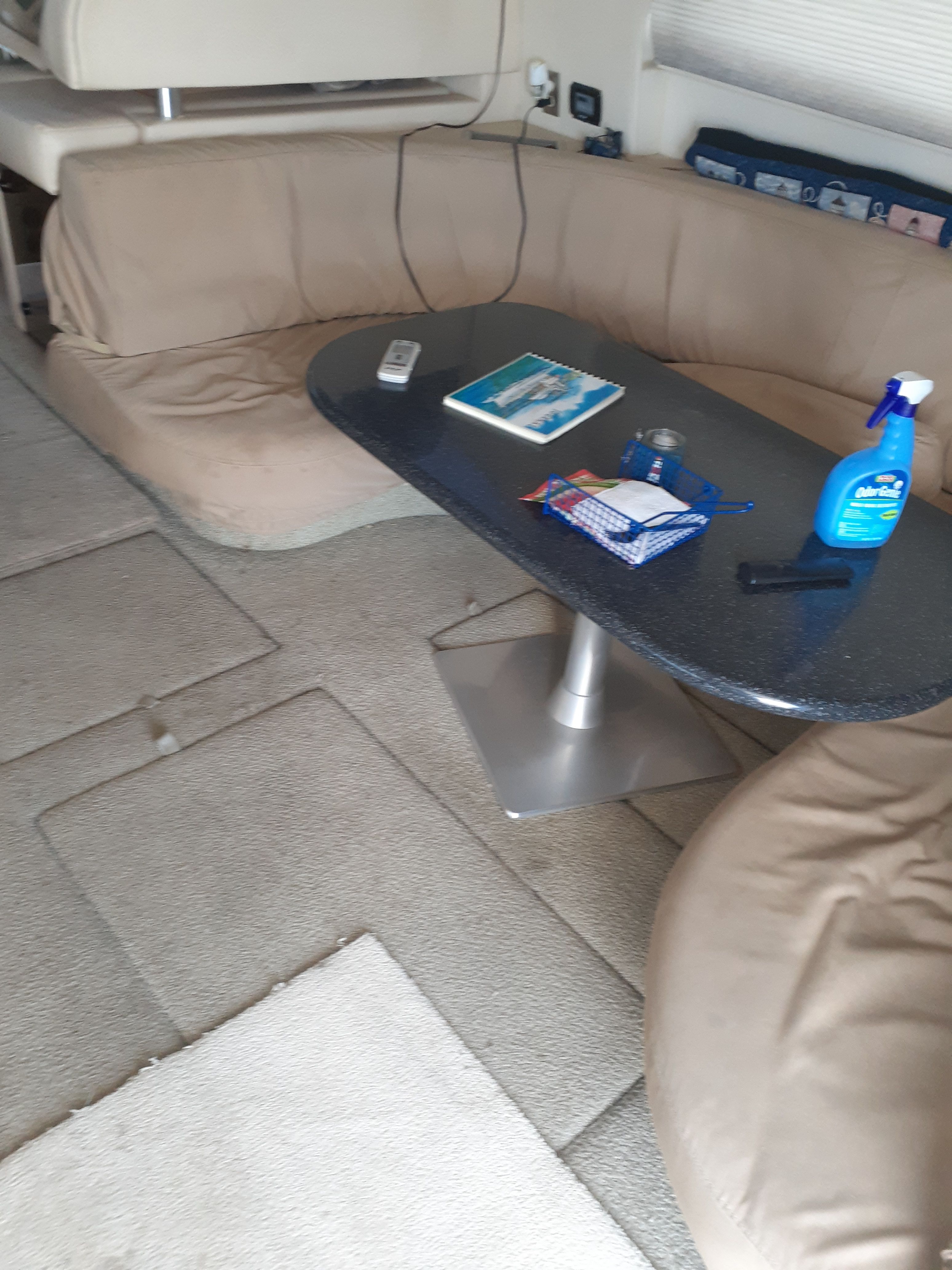 Interior of a 2000 Maxum 4600 SCB with beige sofa and table.