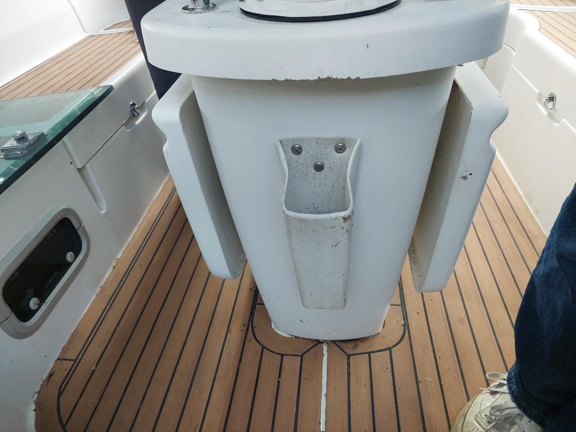 Cockpit of 1995 Beneteau Oceanis 351 sailboat with teak flooring and pedestal.