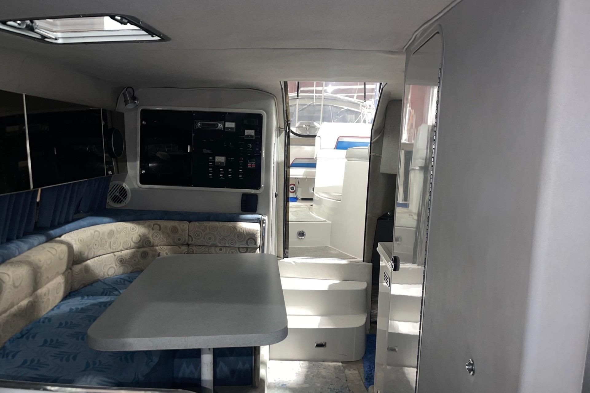Interior of 1992 Chaparral Signature 30 boat with seating and control panel.