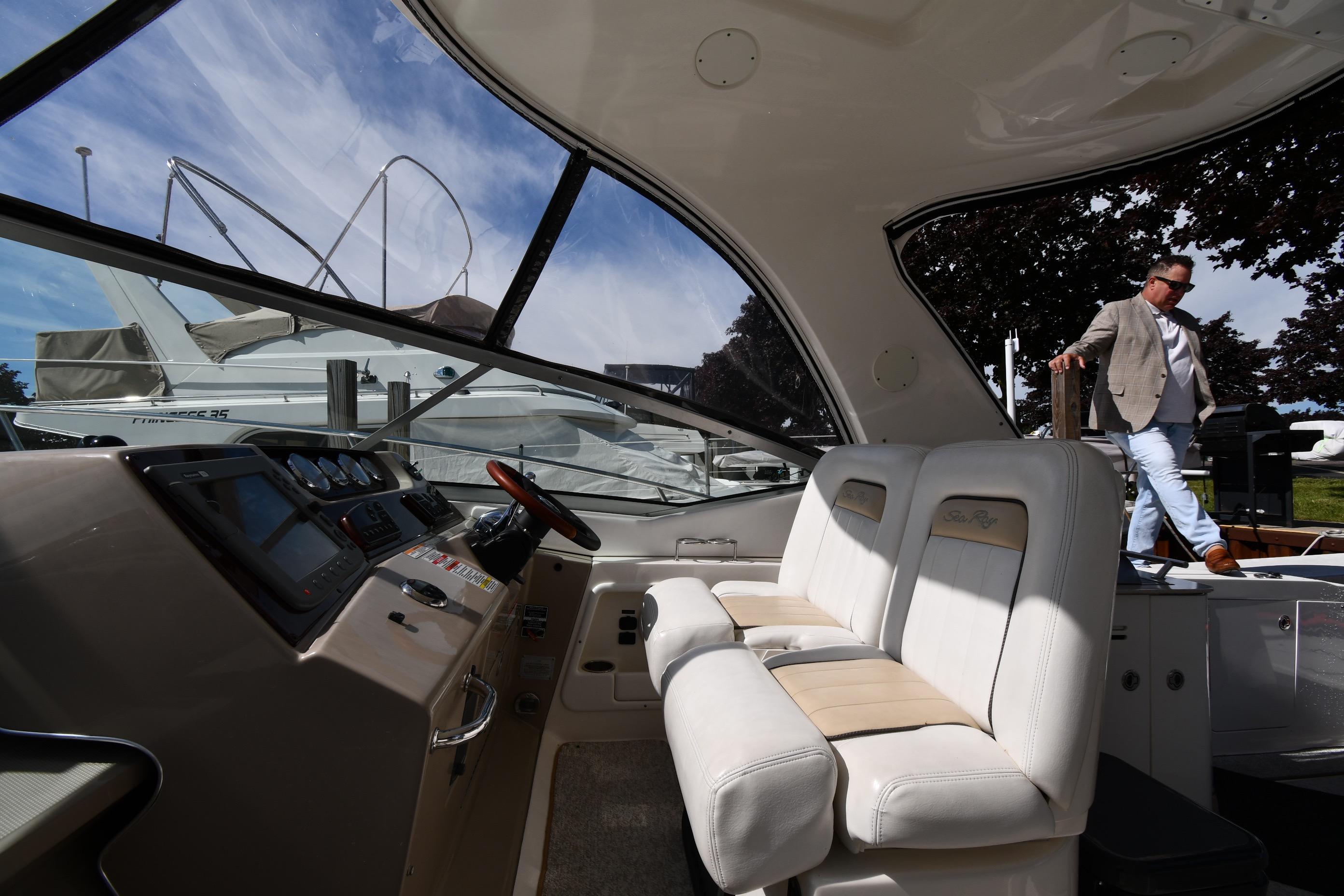 Interior view of 2008 Sea Ray Sundancer 350 yacht with man stepping aboard.