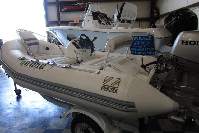 2000 Zodiac Yachtline 340DL inflatable boat with Honda outboard motor in showroom.