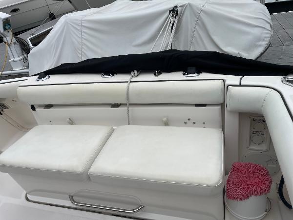 2003 Tiara Yachts 3500 Open boat seating area with white cushions and docked cover.