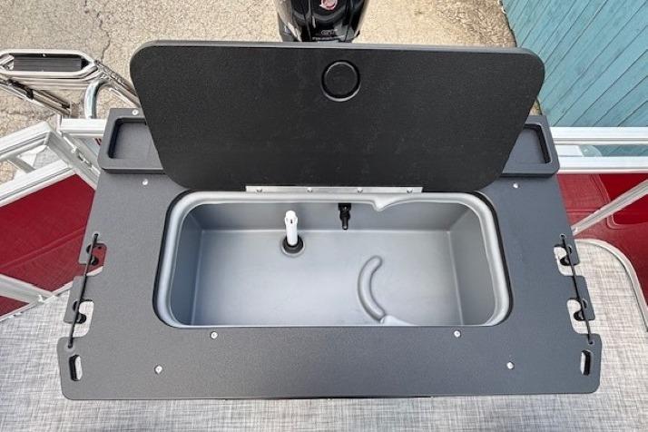 2026 Sun Tracker SportFish 20 DLX livewell with open lid, showcasing interior features.