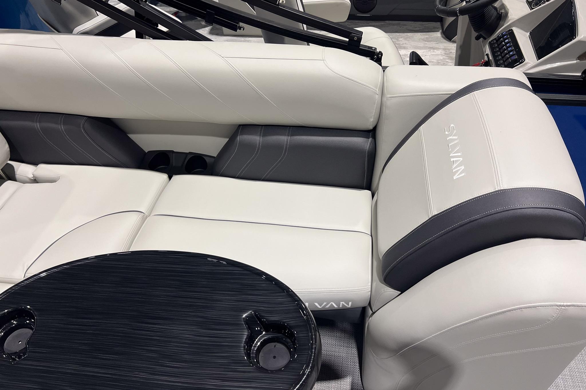 2026 Sylvan Mirage 822 CLZ boat interior with luxurious seating and sleek table design.