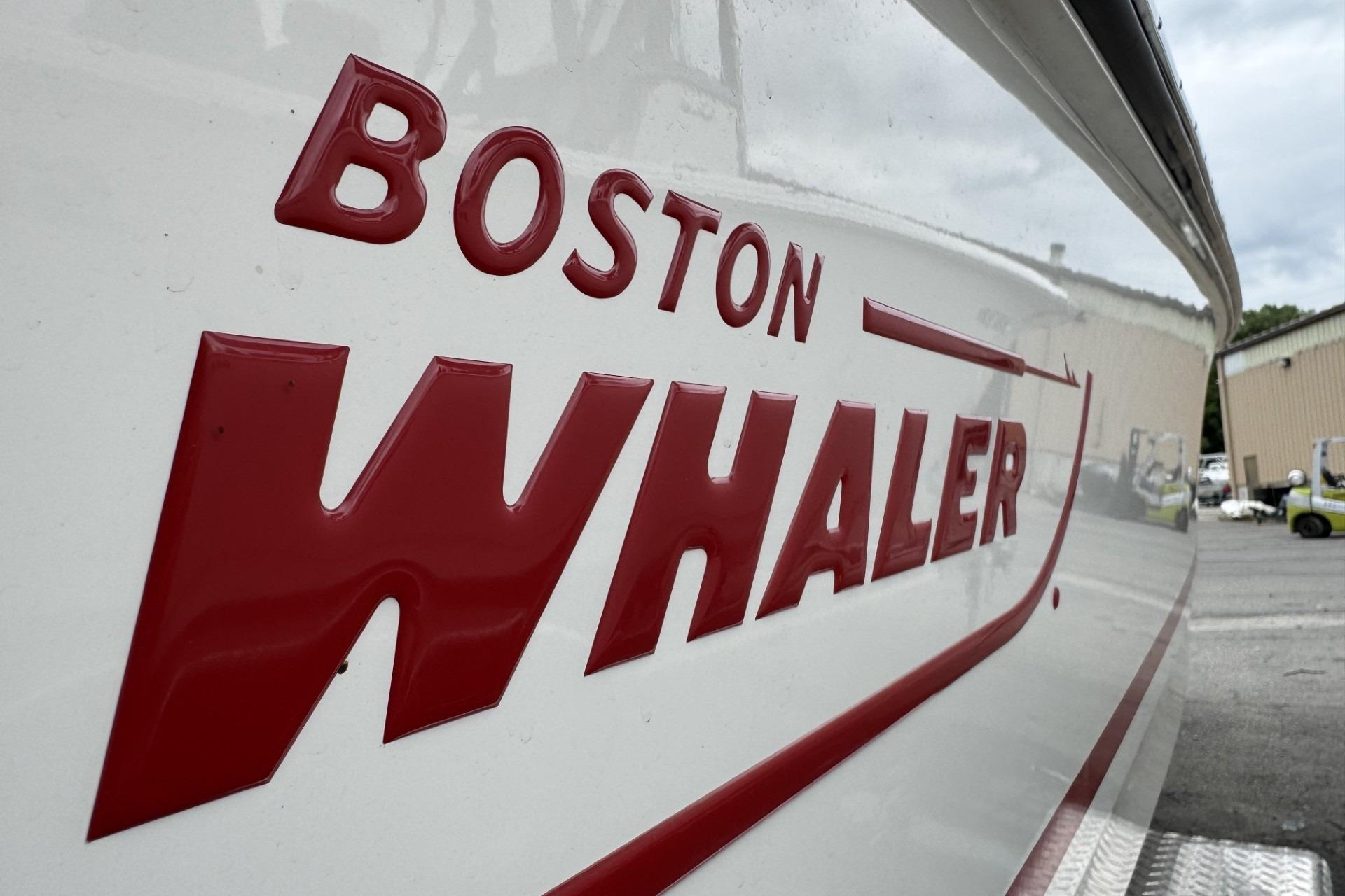 2024 Boston Whaler 230 Outrage boat logo in bold red lettering.
