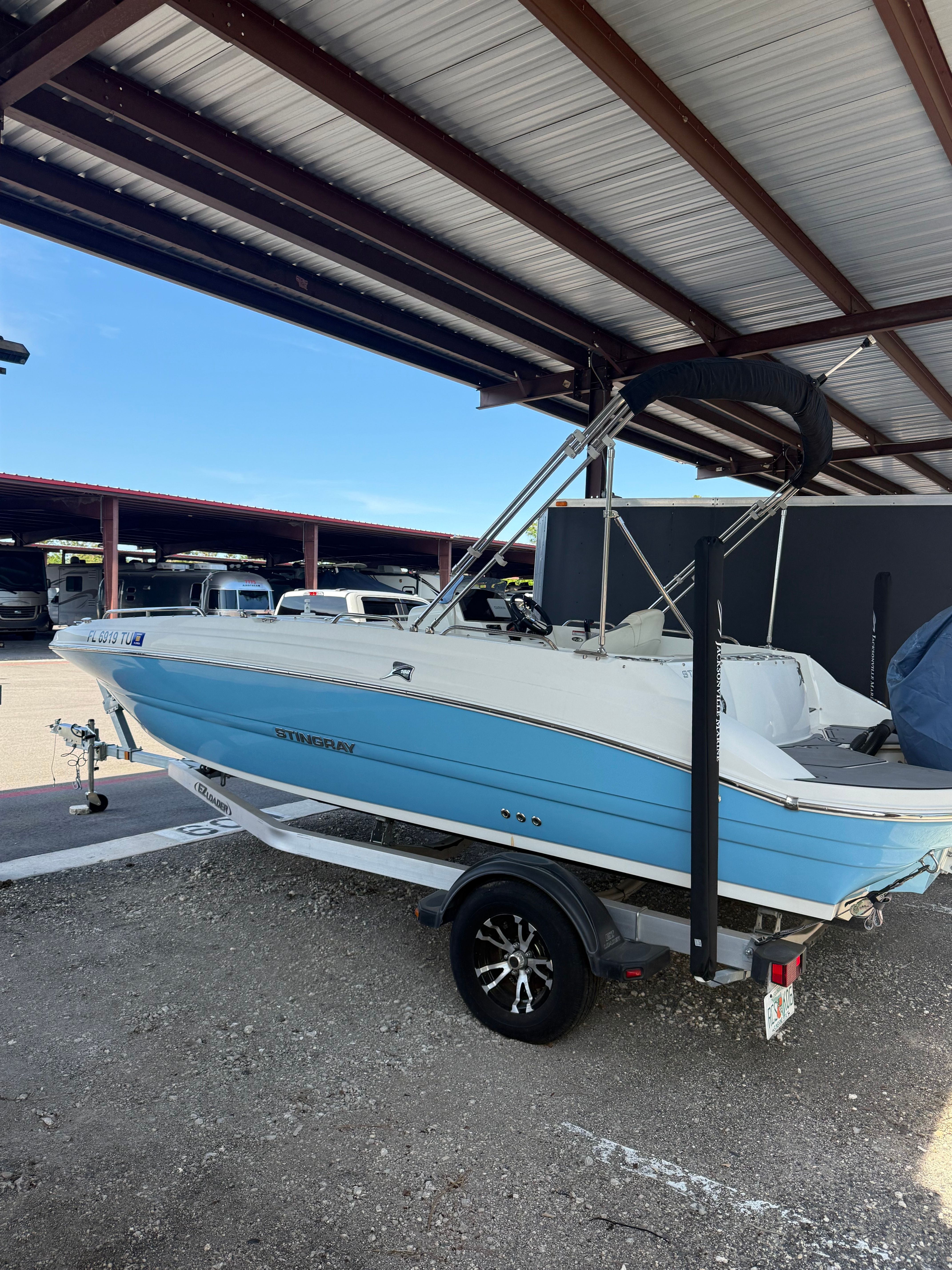 2023 Stingray 192 SC boat under covered parking.