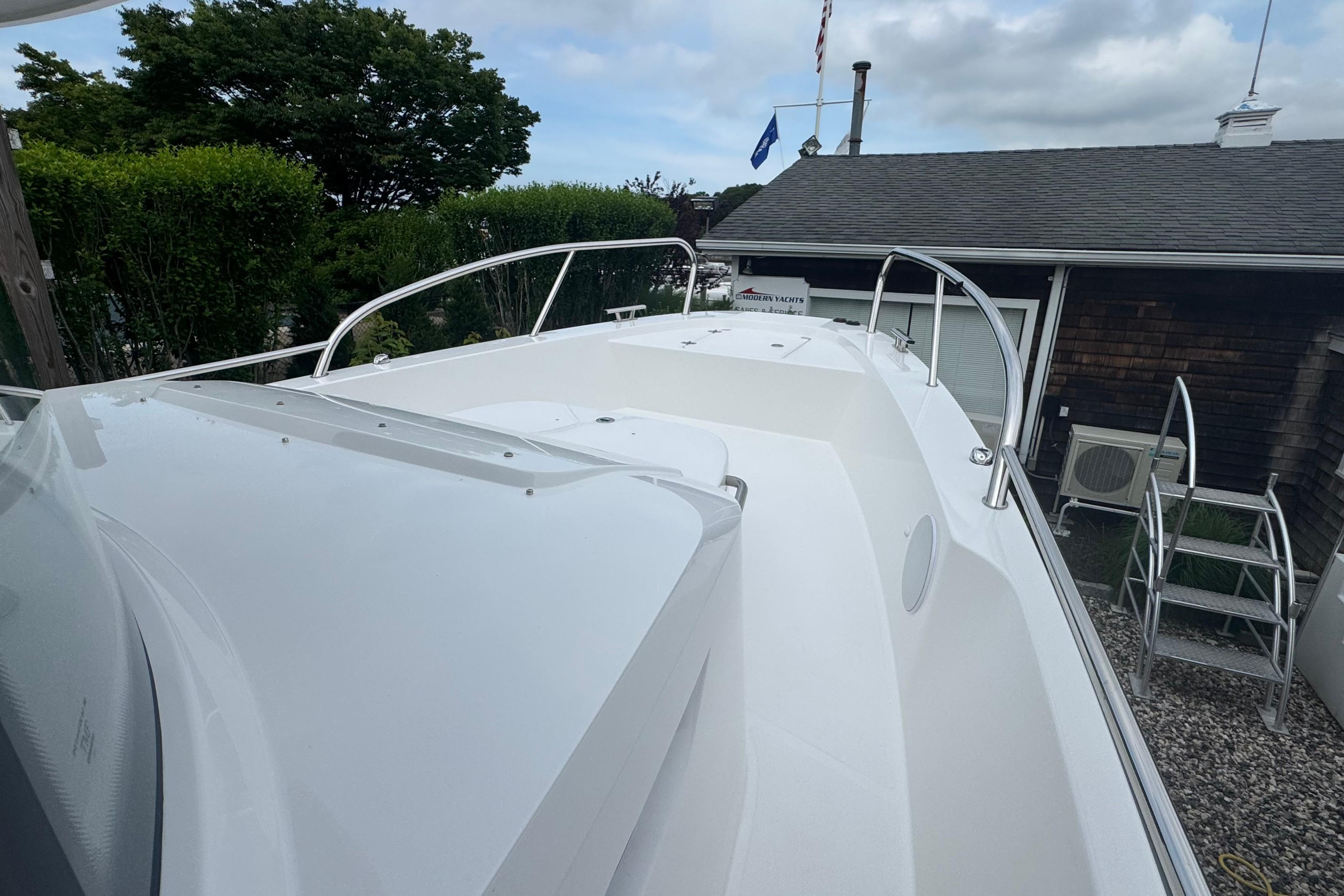 The image shows the deck of a Nimbus Commuter 9 boat situated in a yard.