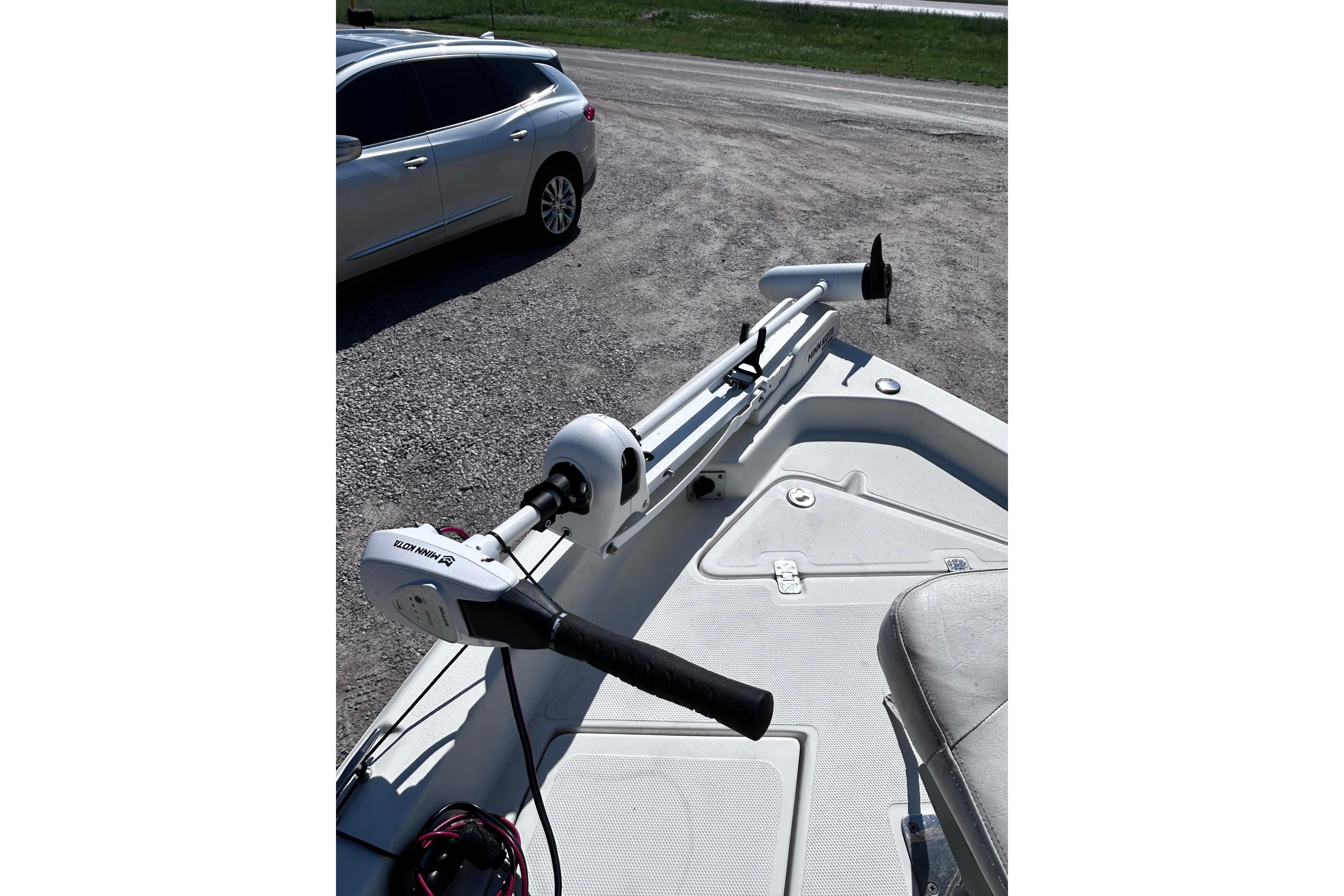2016 NauticStar 1810 NauticBay boat with trolling motor in parking lot.