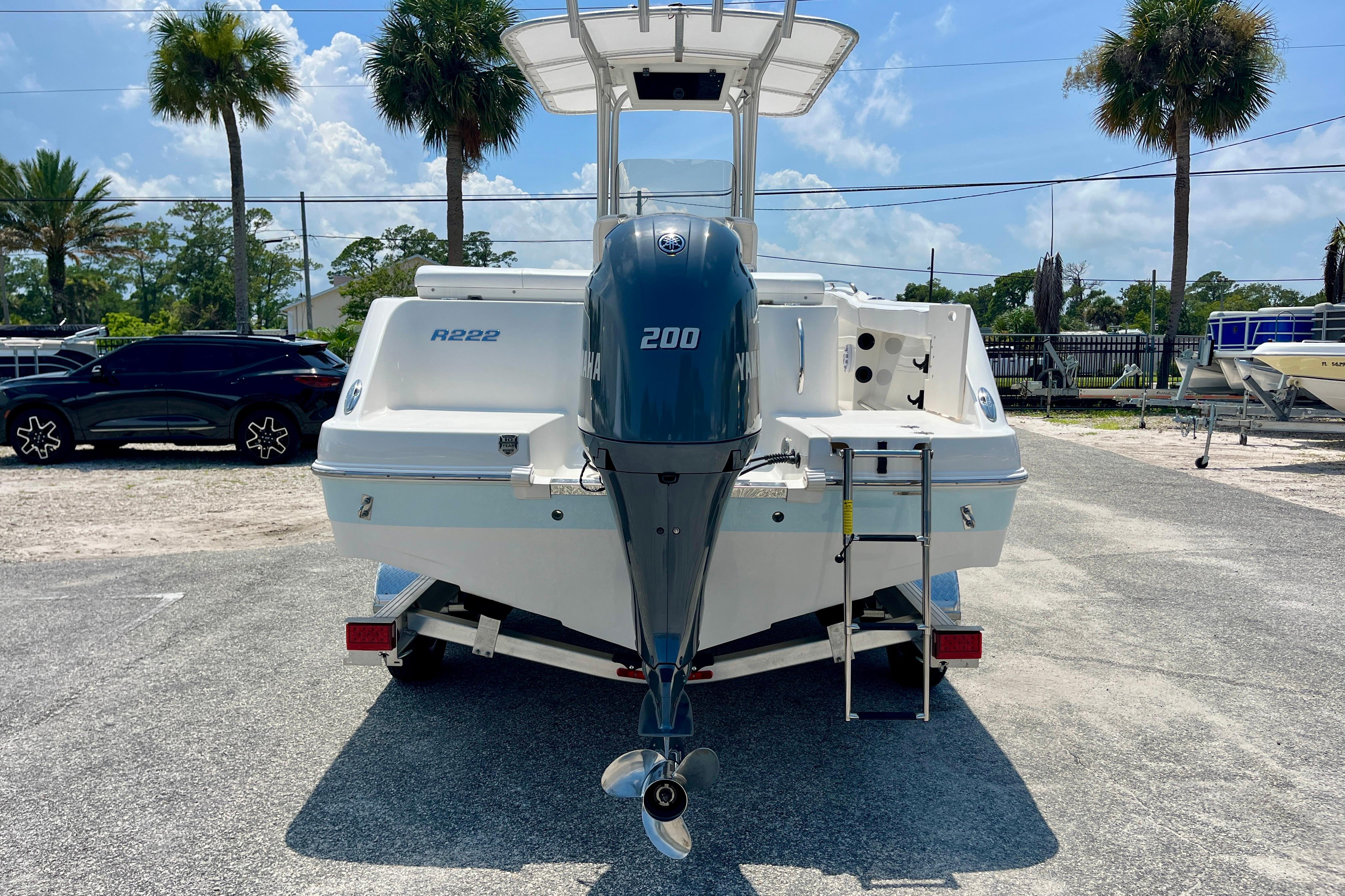 2016 Robalo R222 Center Console boat with Yamaha 200 engine, parked outdoors.