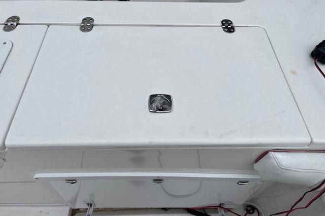2001 Fountain 38 Center Console boat deck with storage compartment.