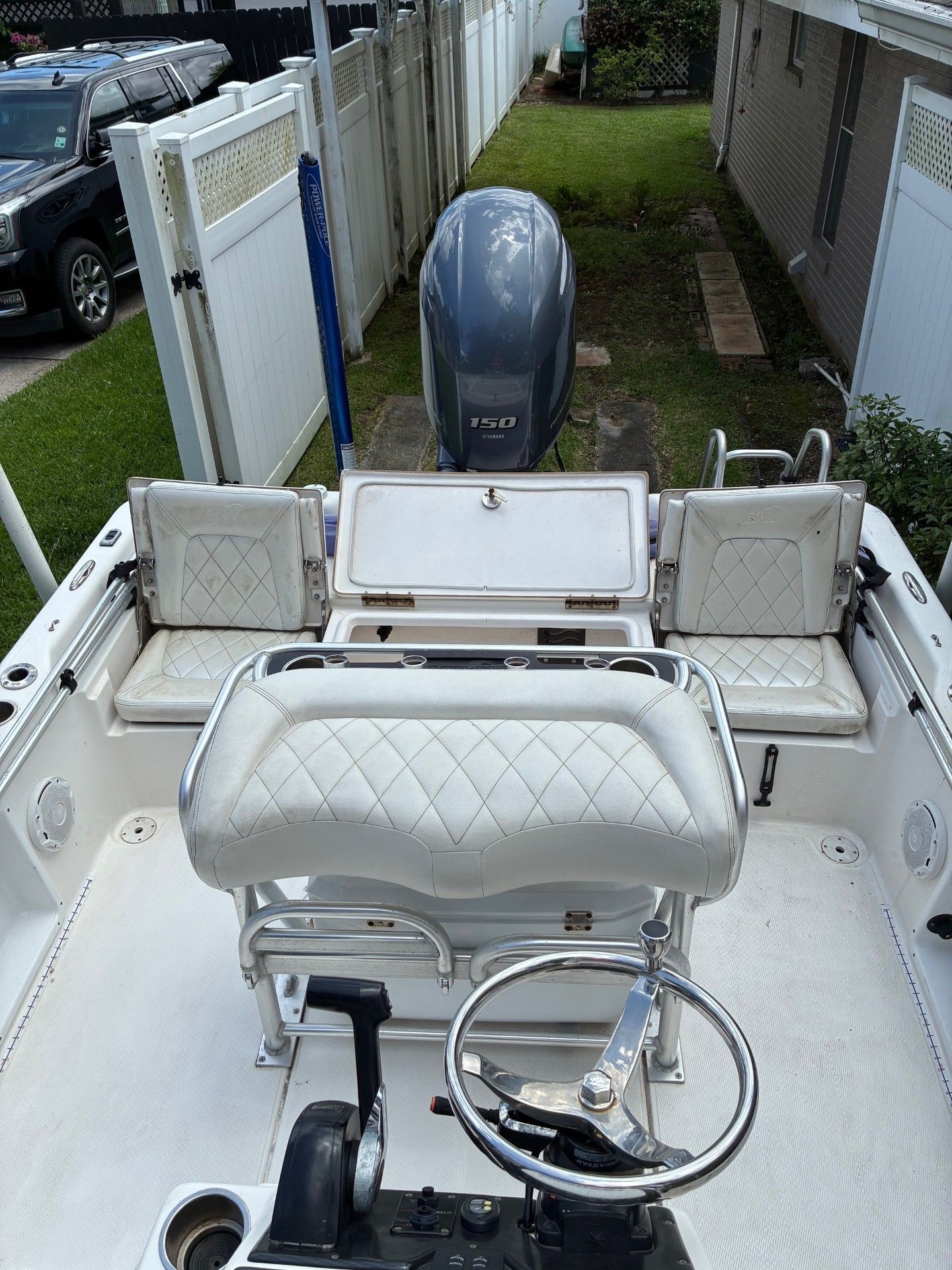 The image shows the cockpit of a 2018 Custom 2200 Pure Bay boat with white seating.