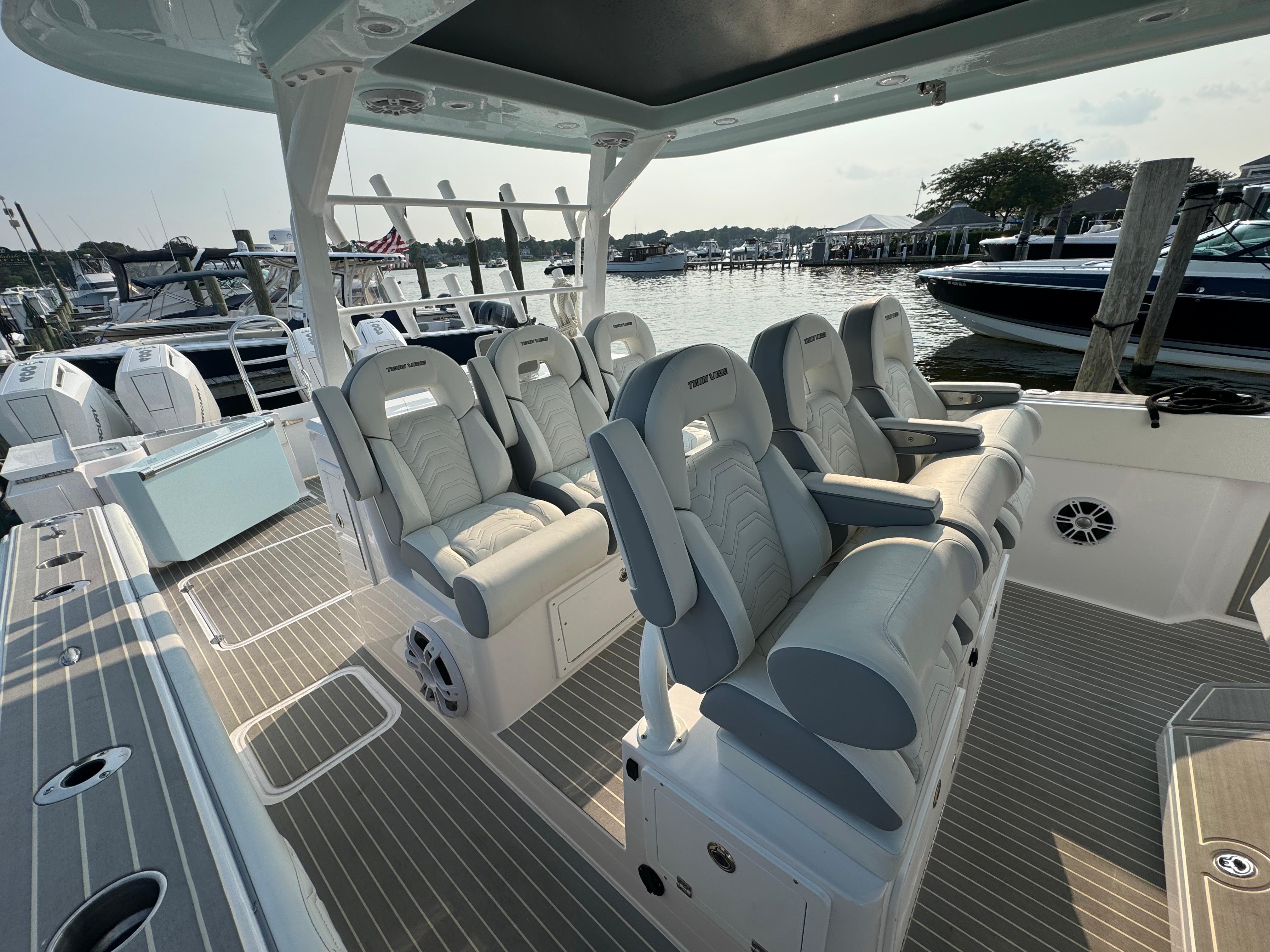 2025 Twin Vee 400 GFX boat interior with luxurious seating at a marina.