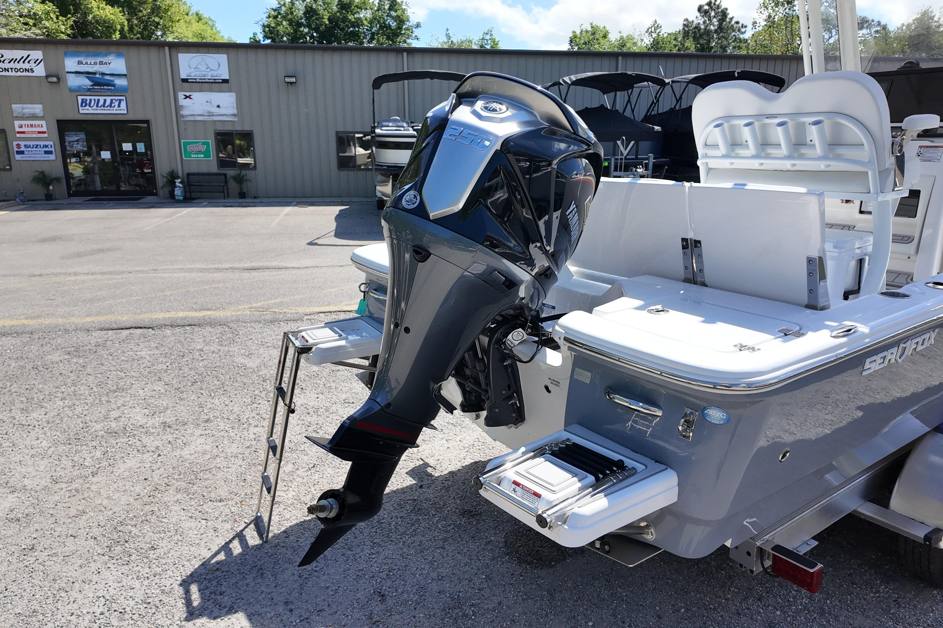 2026 Sea Fox 251 Bay Fox boat with powerful outboard motor in dealership lot.