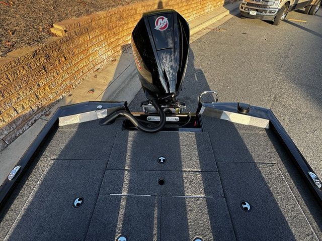 2024 Vexus AVX2080 boat with powerful outboard motor, parked on a street.