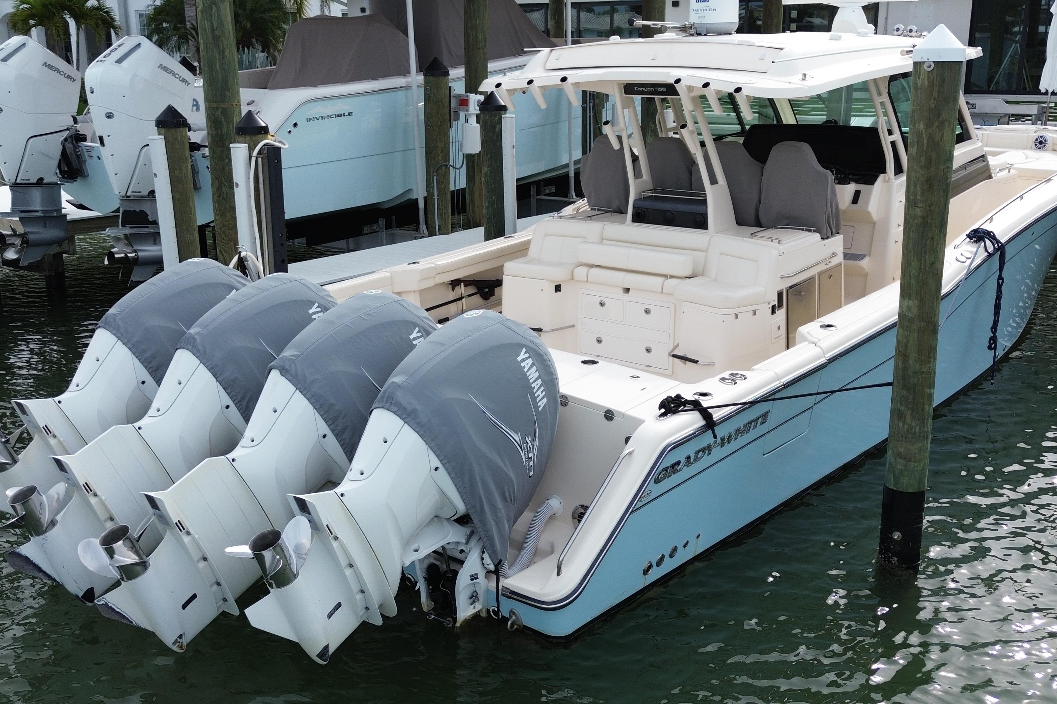 2019 Grady-White Canyon 456 boat with four Yamaha outboard engines docked in marina.