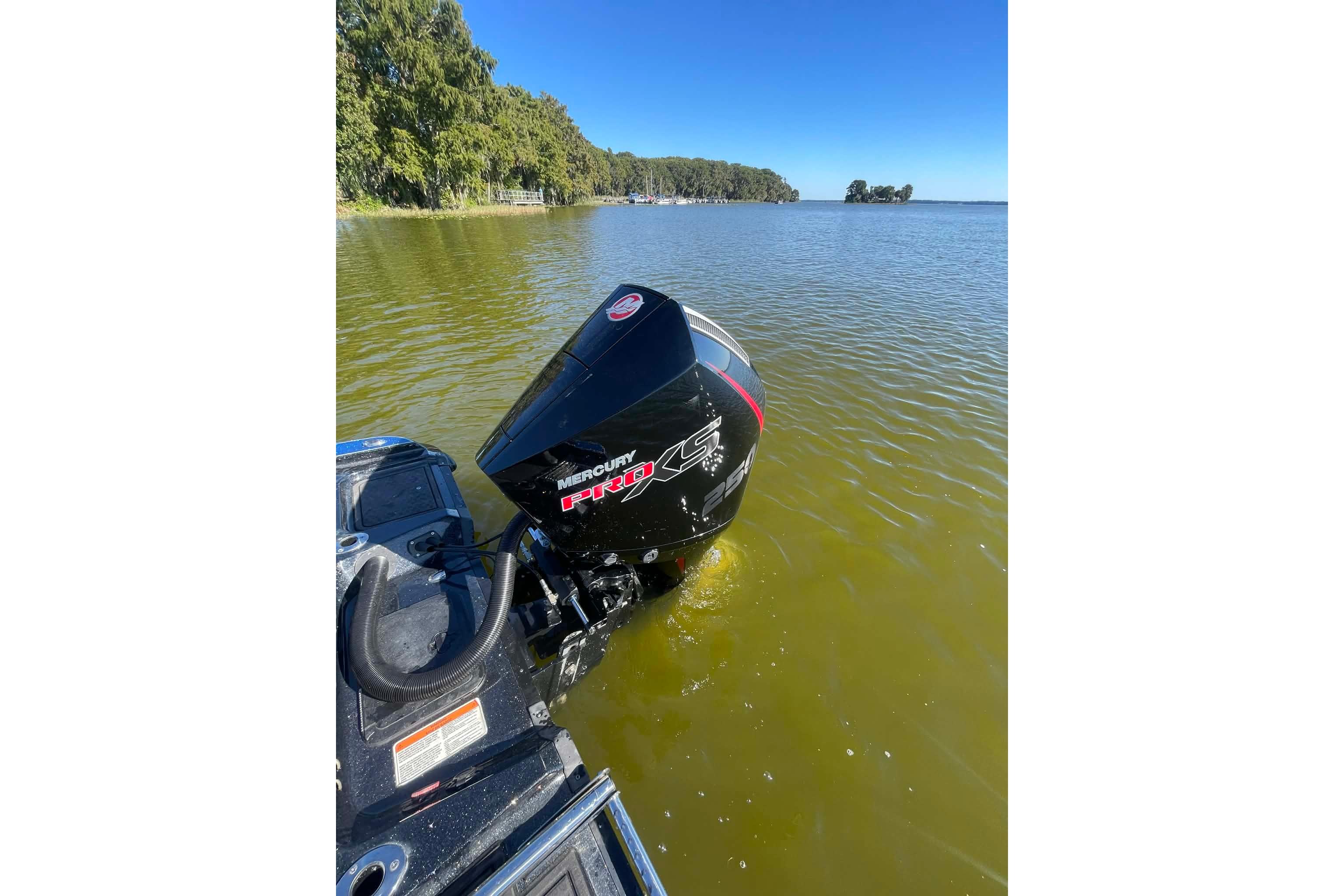 2024 Nitro ZV21 boat with Mercury Pro XS engine on a calm lake.