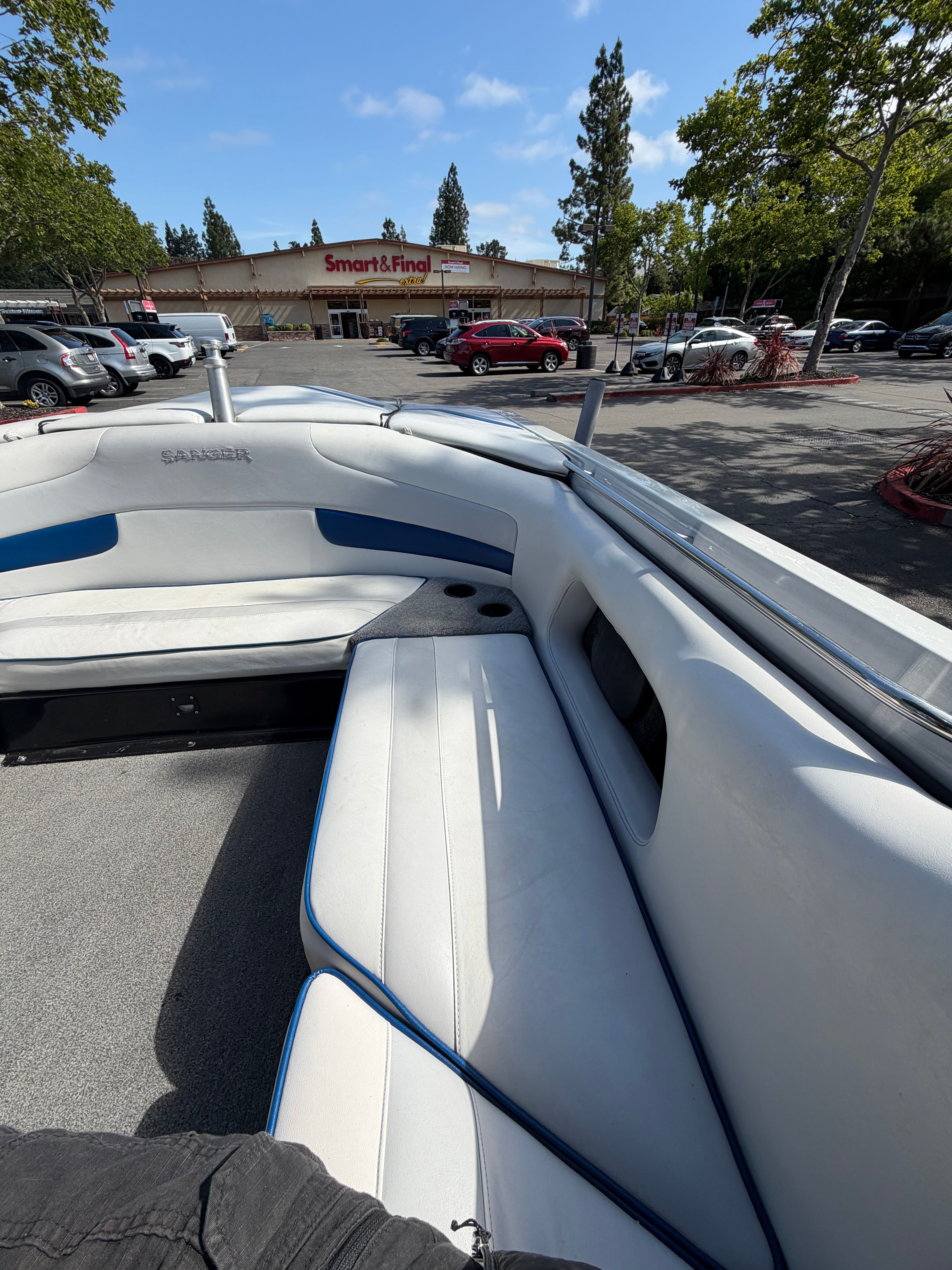 The image shows the interior of a 2001 Sanger V210 boat with white seating.