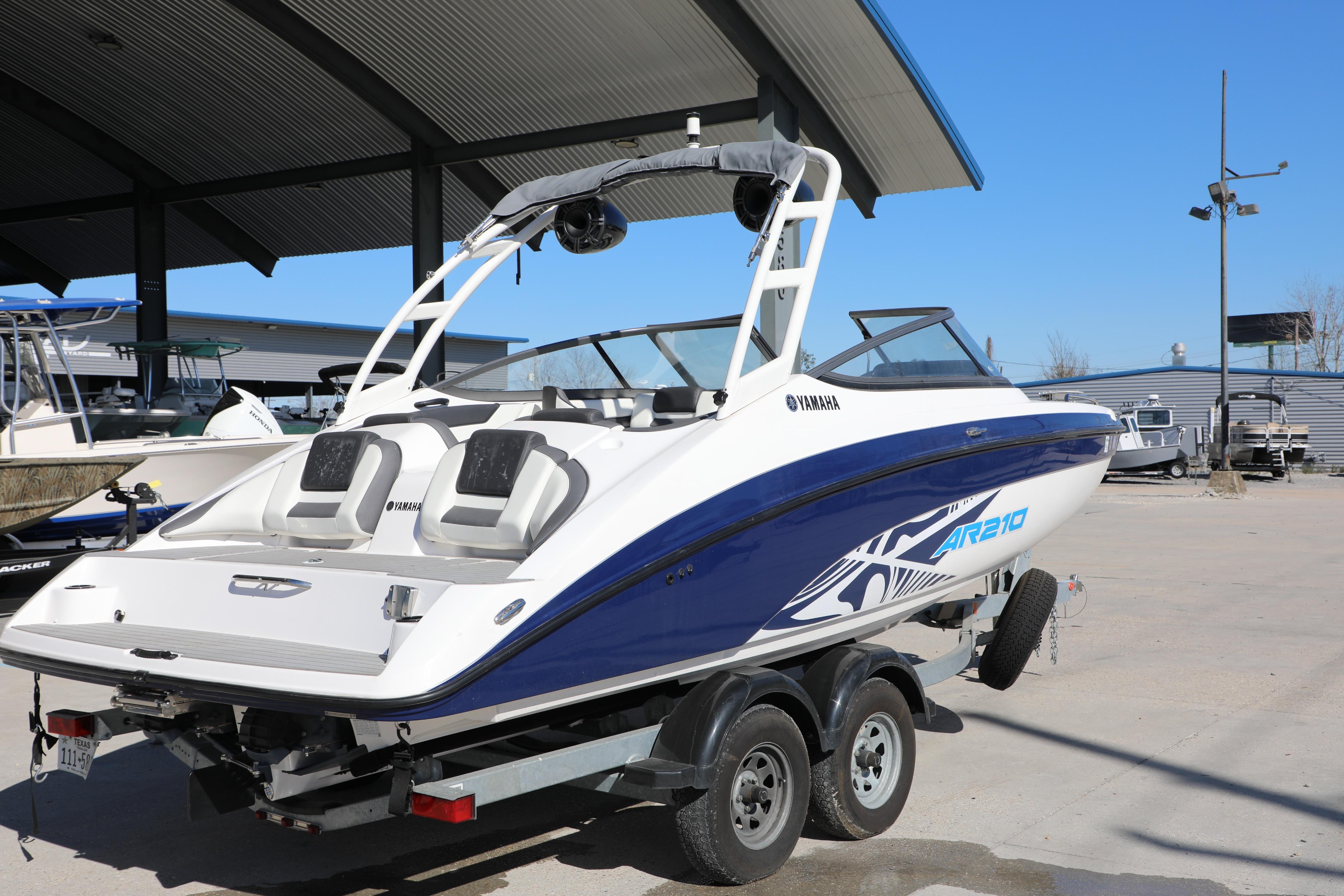 2022 Yamaha AR210 boat on trailer, parked outdoors under a canopy.