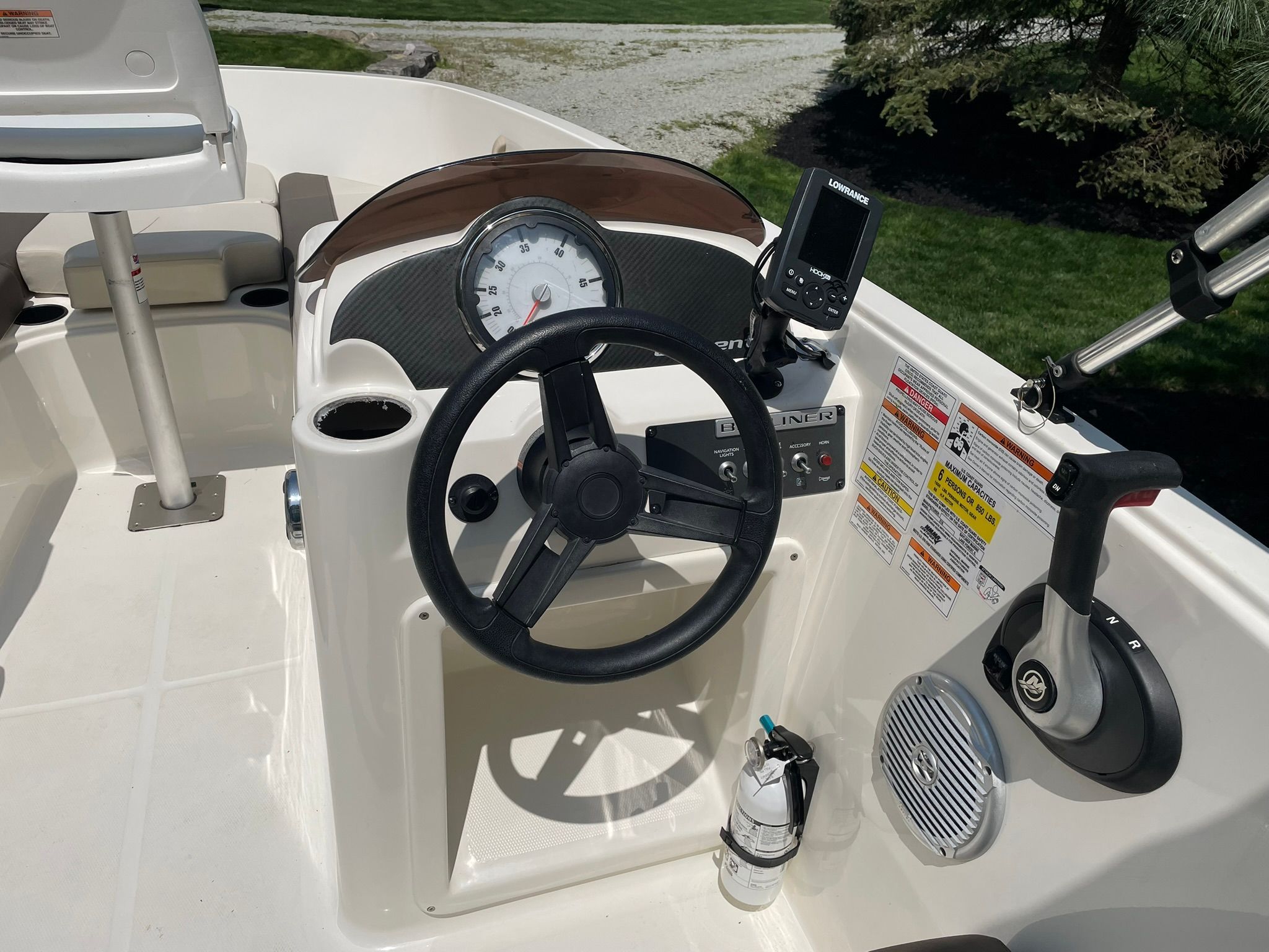 The image shows the helm of a 2018 Bayliner 160 Bowrider with instruments and controls.