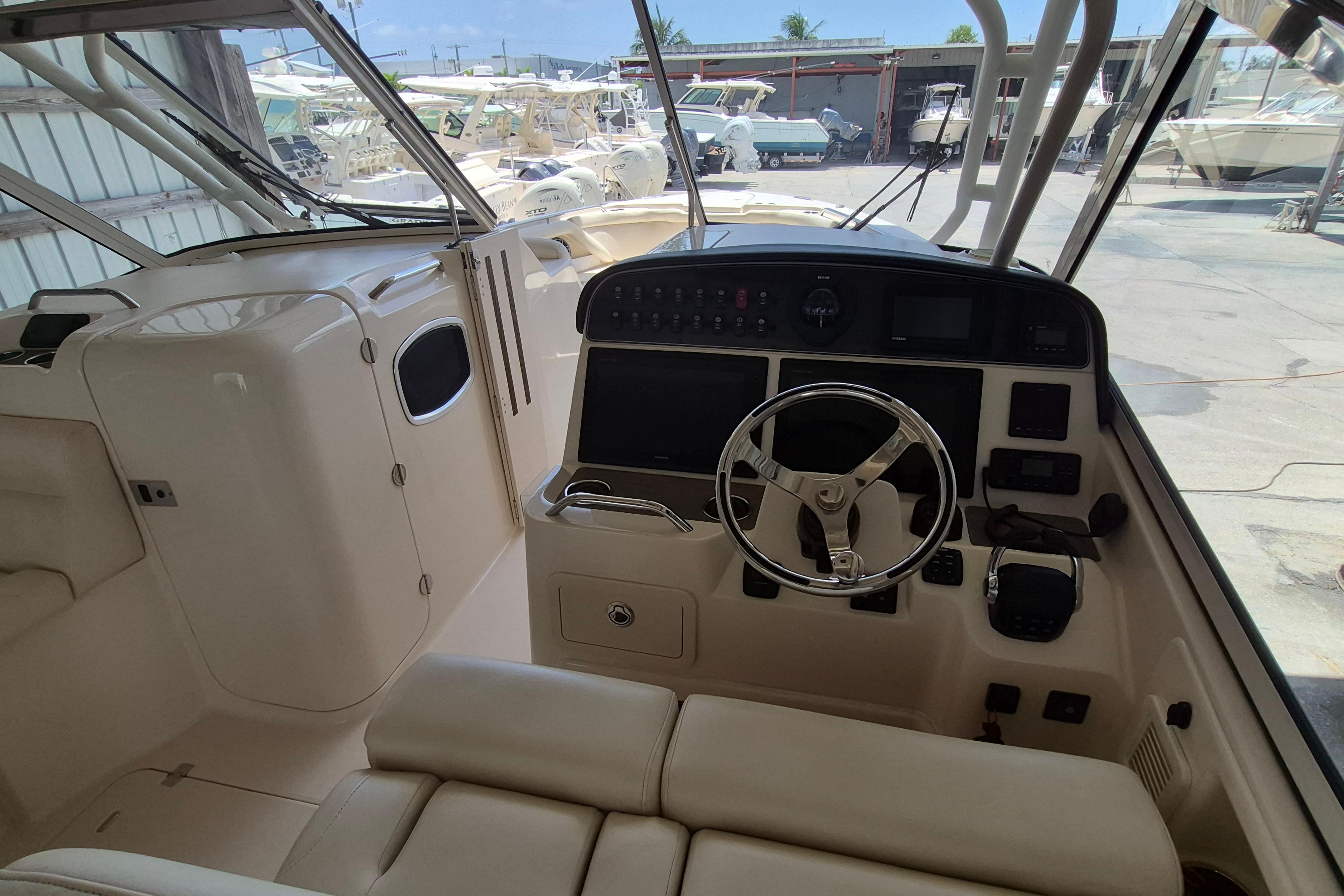 2019 Grady-White Freedom 335 boat cockpit with steering wheel and control panel.