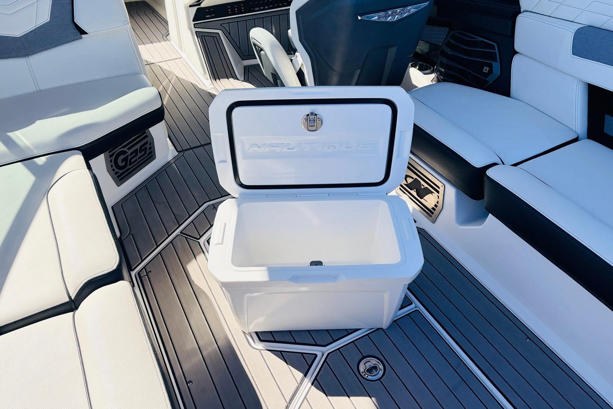 2023 Nautique Super Air Nautique G25 interior with open cooler on deck.