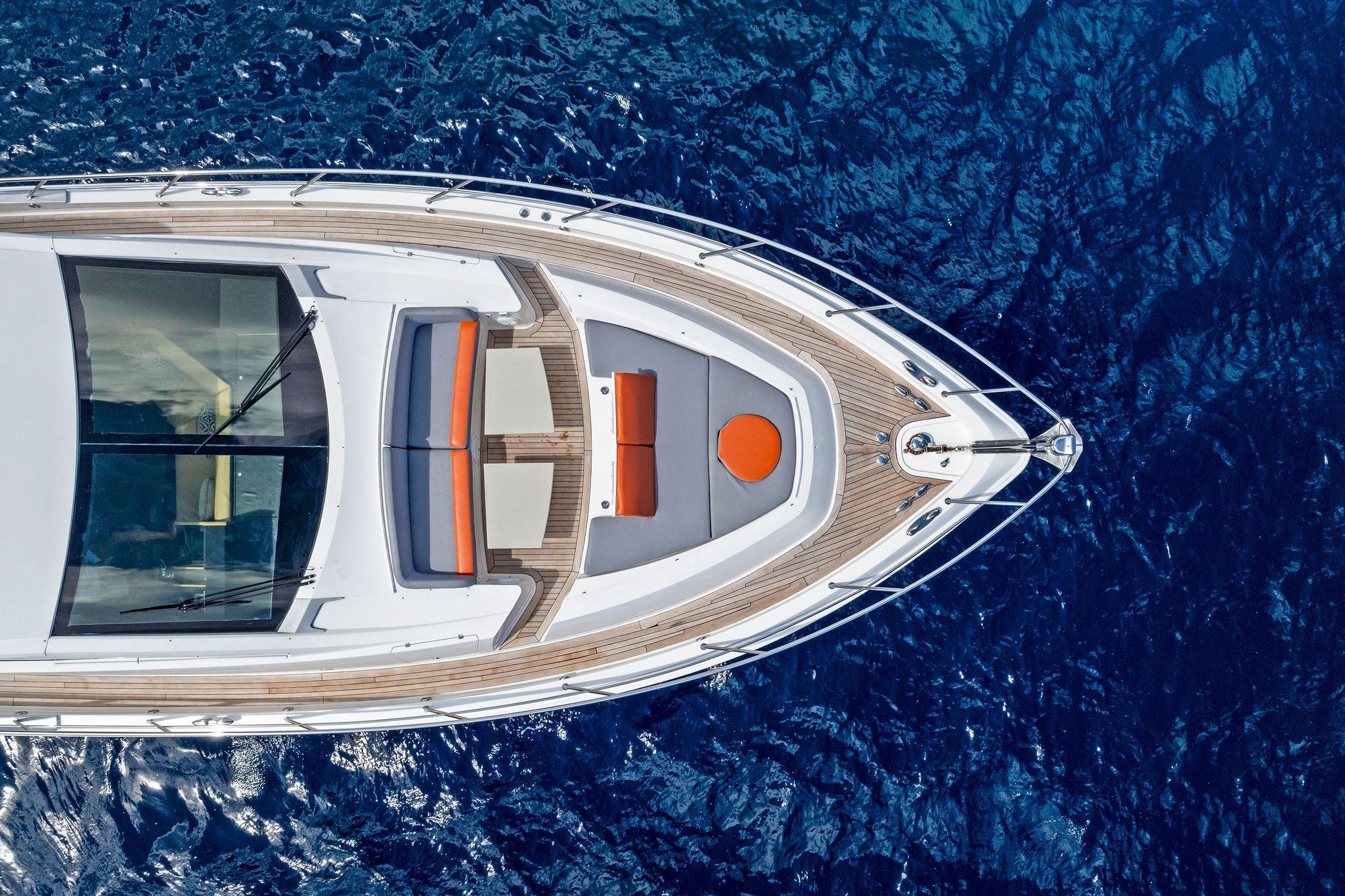 Aerial view of 2014 Lazzara 64 yacht on deep blue ocean waters.