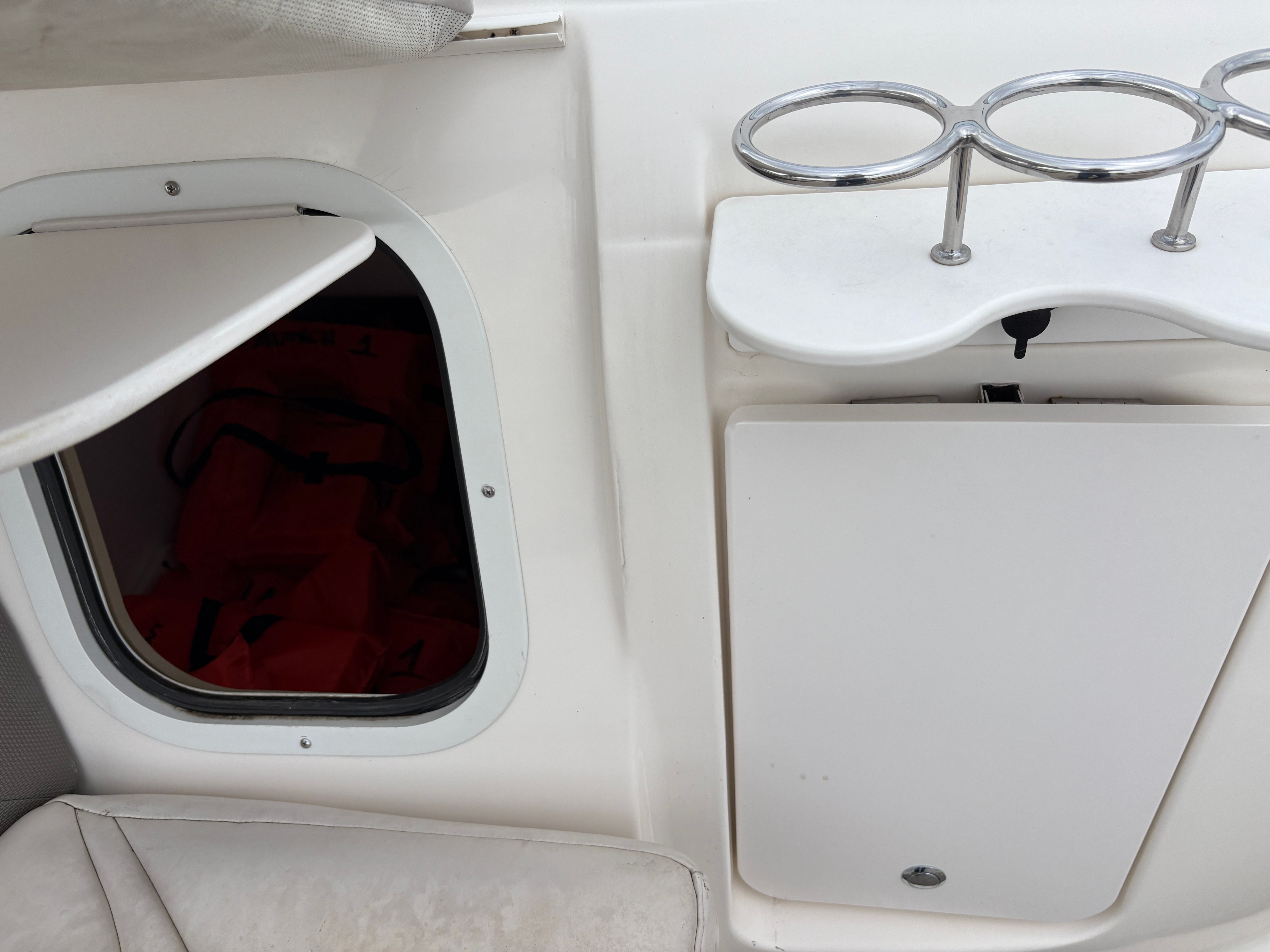 Interior of a 2009 Hurricane SUN DECK 260 boat with storage compartment.