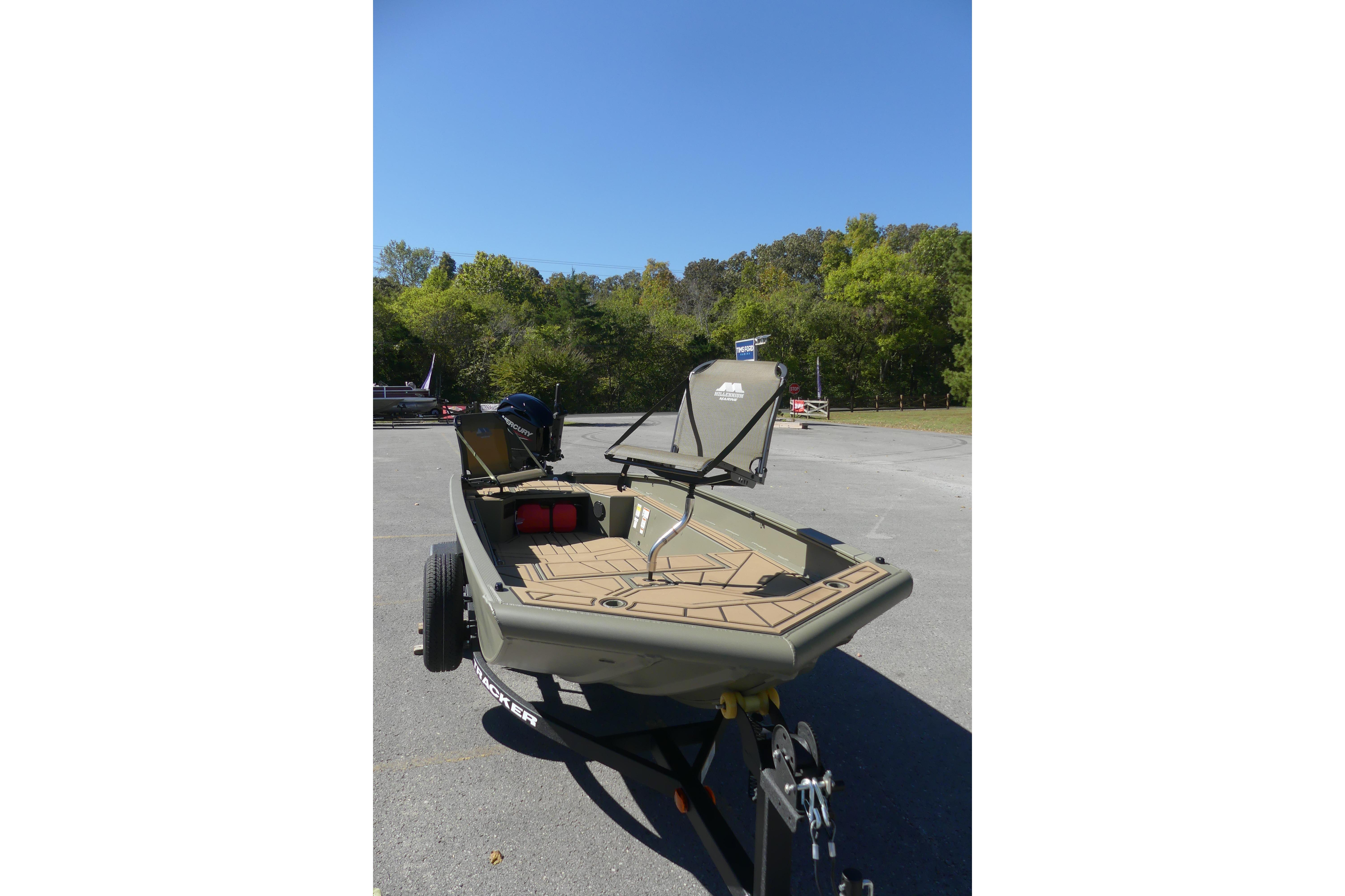 2026 Tracker Grizzly 1650 T Prairie Wings Edition boat on trailer, parked outdoors.