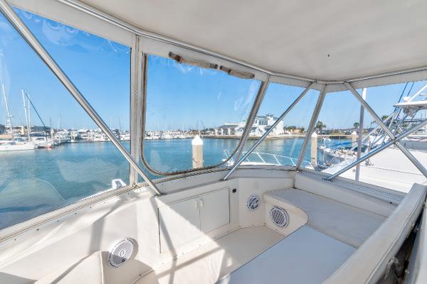 1999 Viking 47 Convertible yacht interior with marina view through windows.