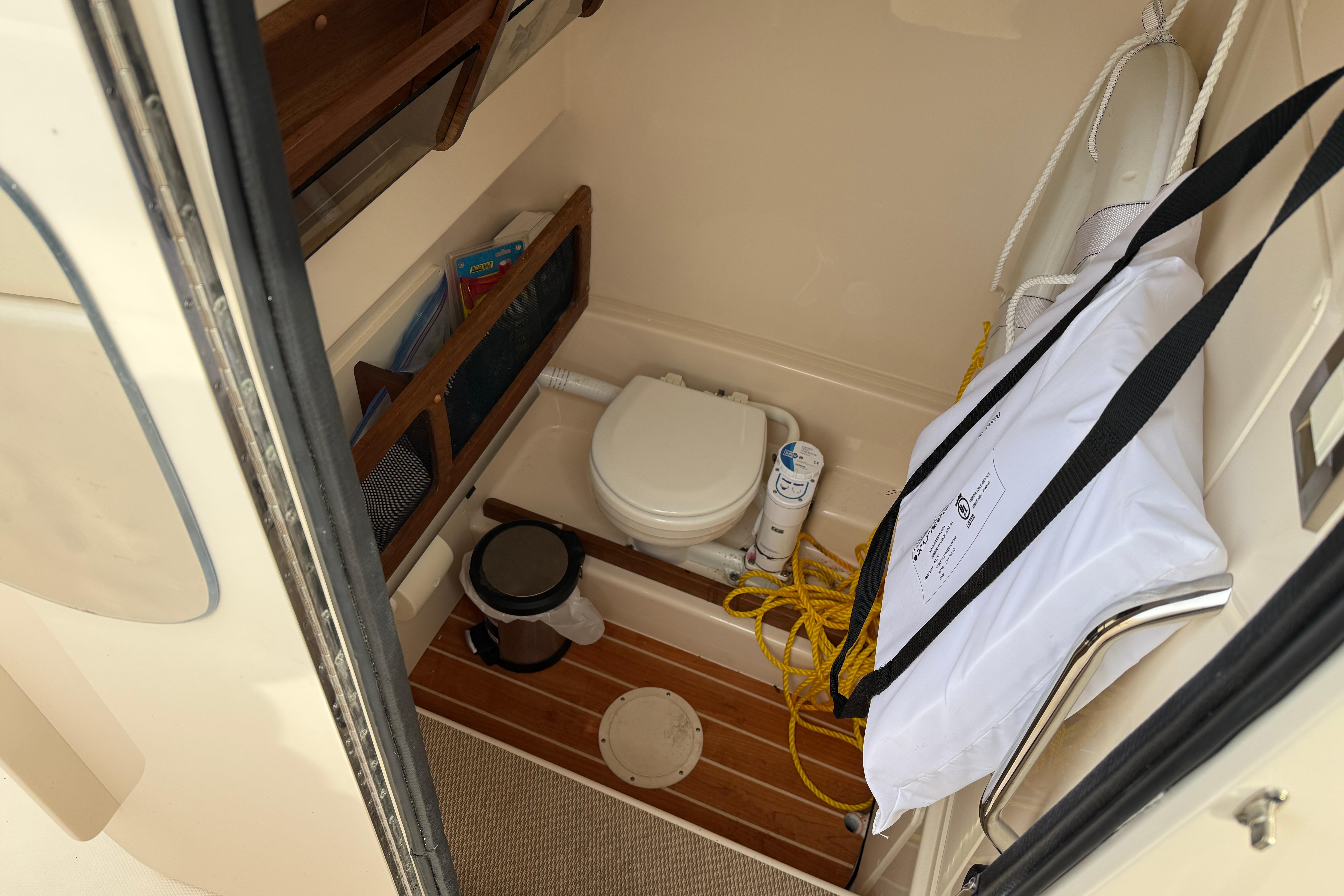 2024 Grady-White Canyon 271 boat interior with compact bathroom amenities.