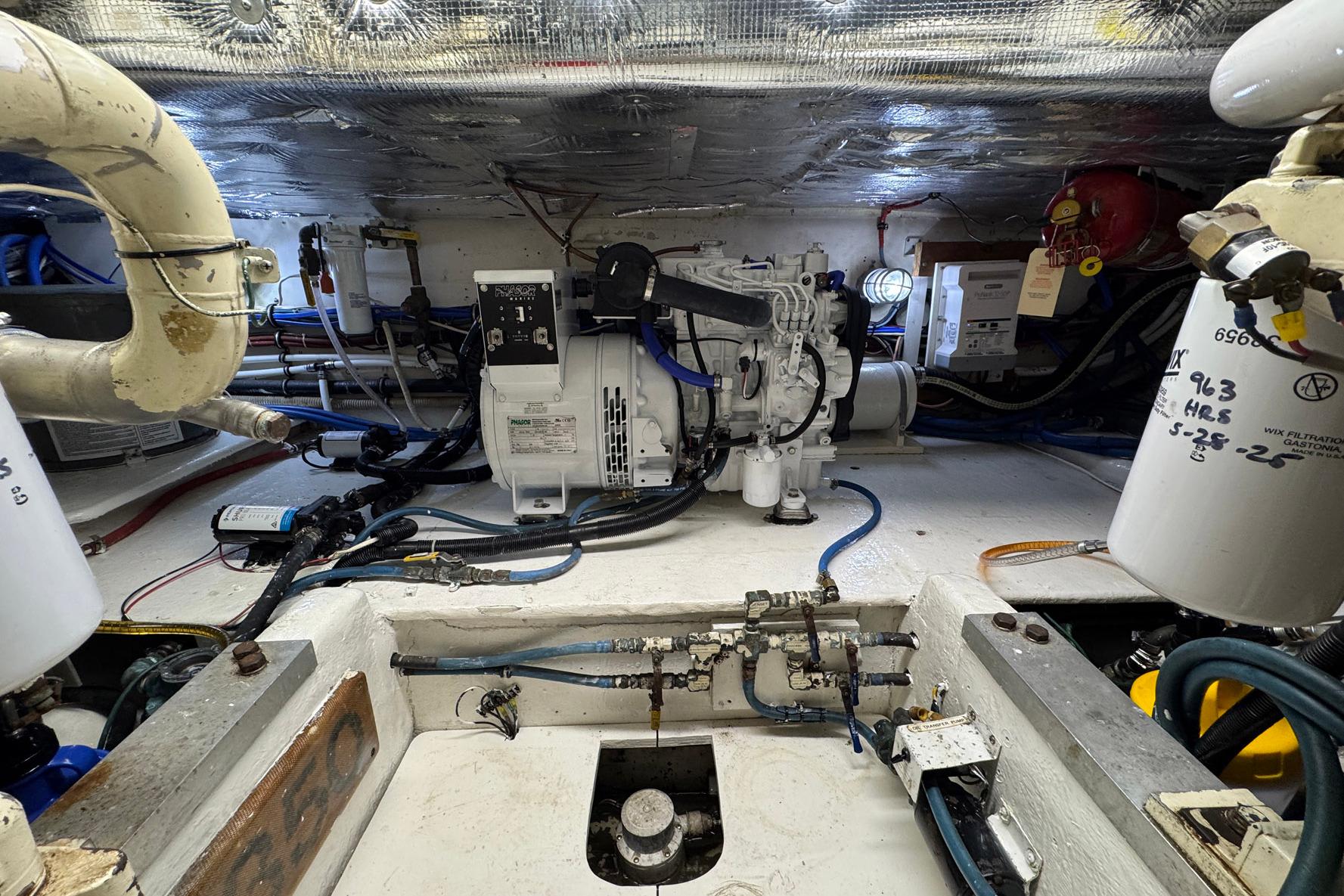 Engine room of 1988 Buddy Davis 47 Convertible with visible machinery and wiring.
