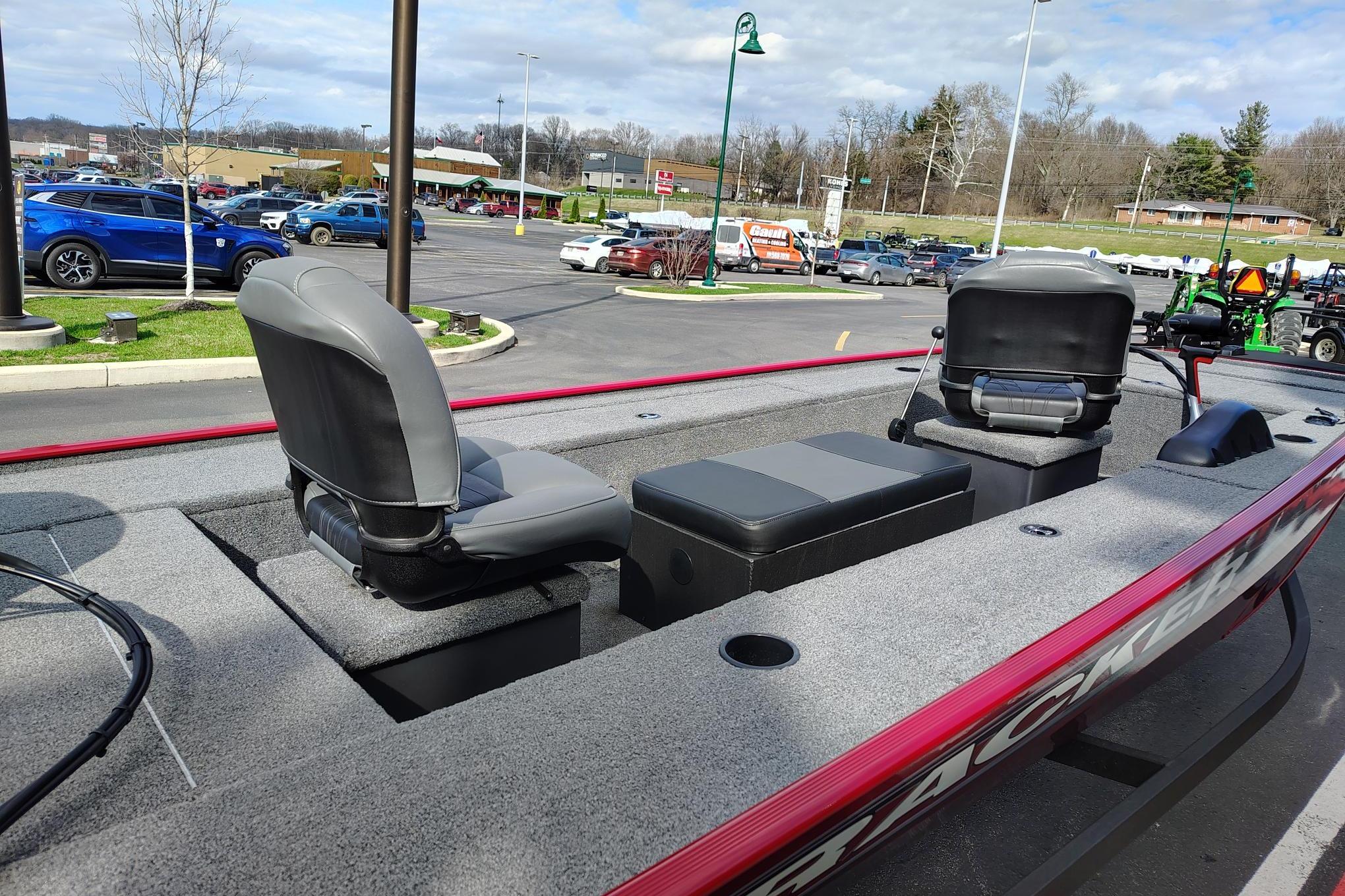 2025 Tracker Panfish 17 boat with seating, parked in a lot under a cloudy sky.