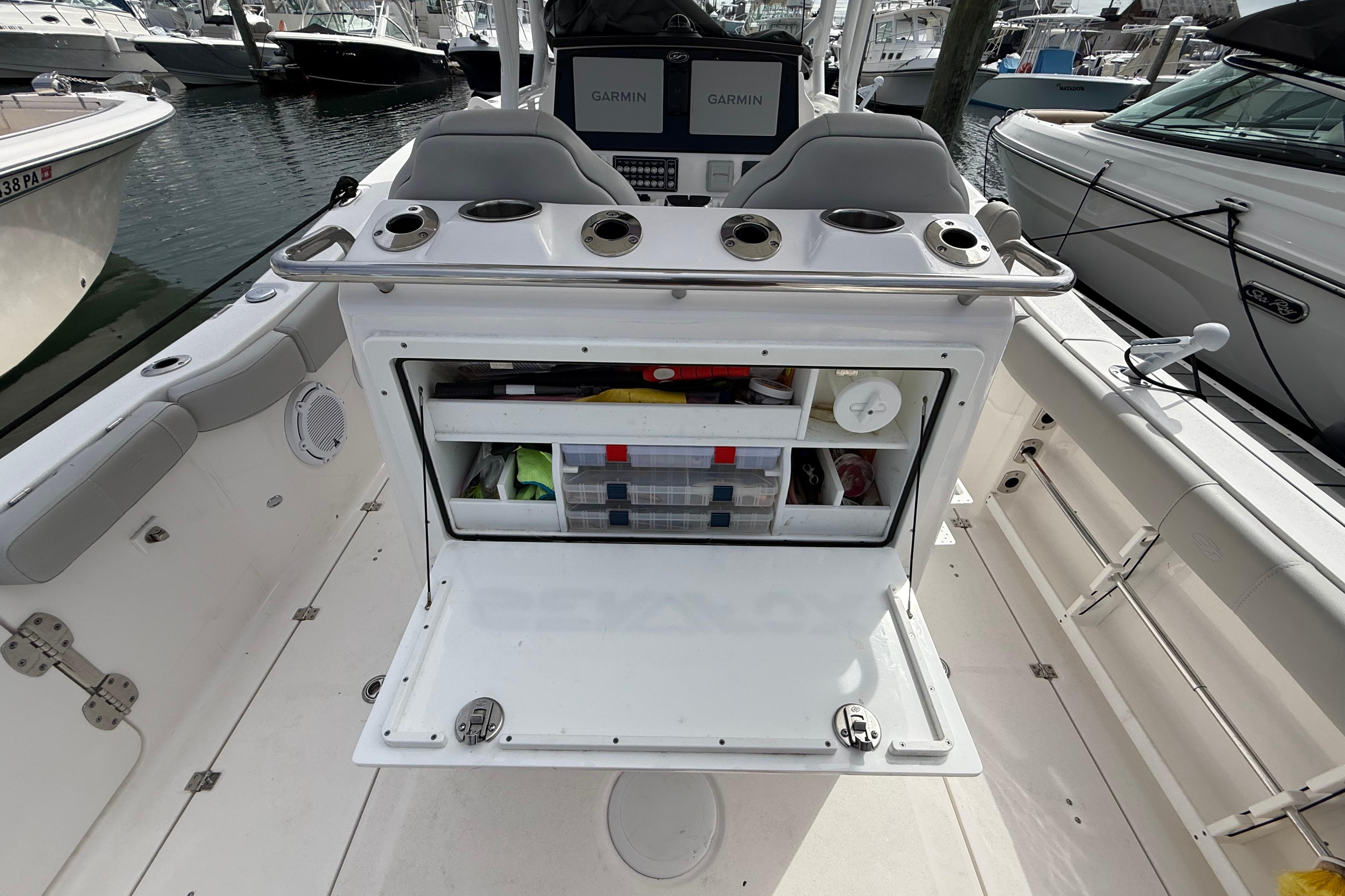 2021 Sea Fox 288 Commander boat interior with open storage compartment and Garmin displays.