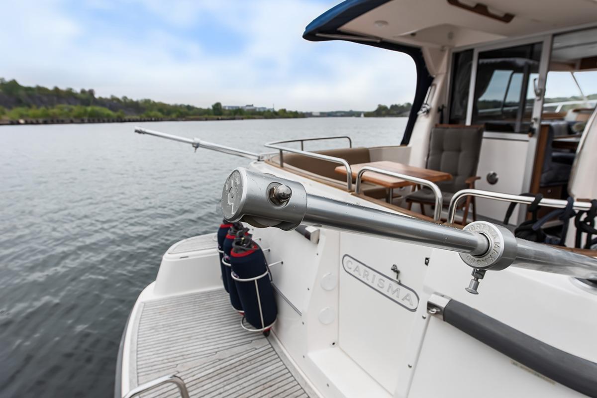 Nimbus 380 Carisma yacht, 2000 model, featuring a spacious deck and scenic waterway view.