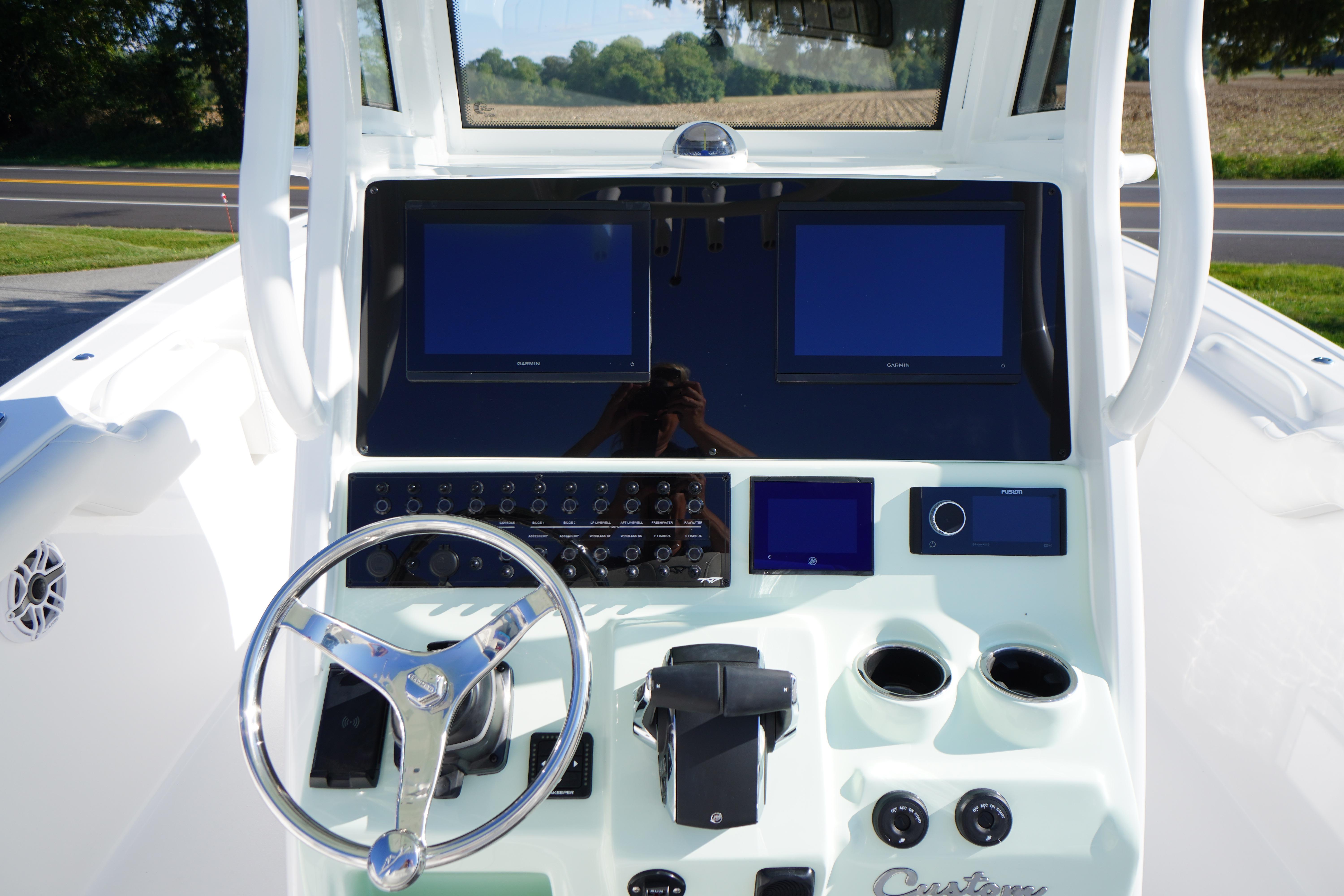 2026 Tidewater 272 LXF boat dashboard with dual screens and steering wheel.
