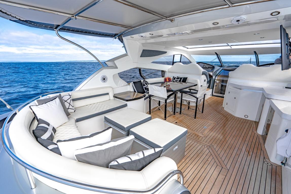 Luxurious Sunseeker Predator 68 yacht interior, 2021 model, featuring elegant seating and ocean view.