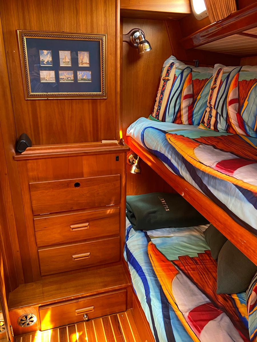 Cozy cabin interior of 2001 Hinckley Sou'wester 59 CC with vibrant bedding and wooden furnishings.