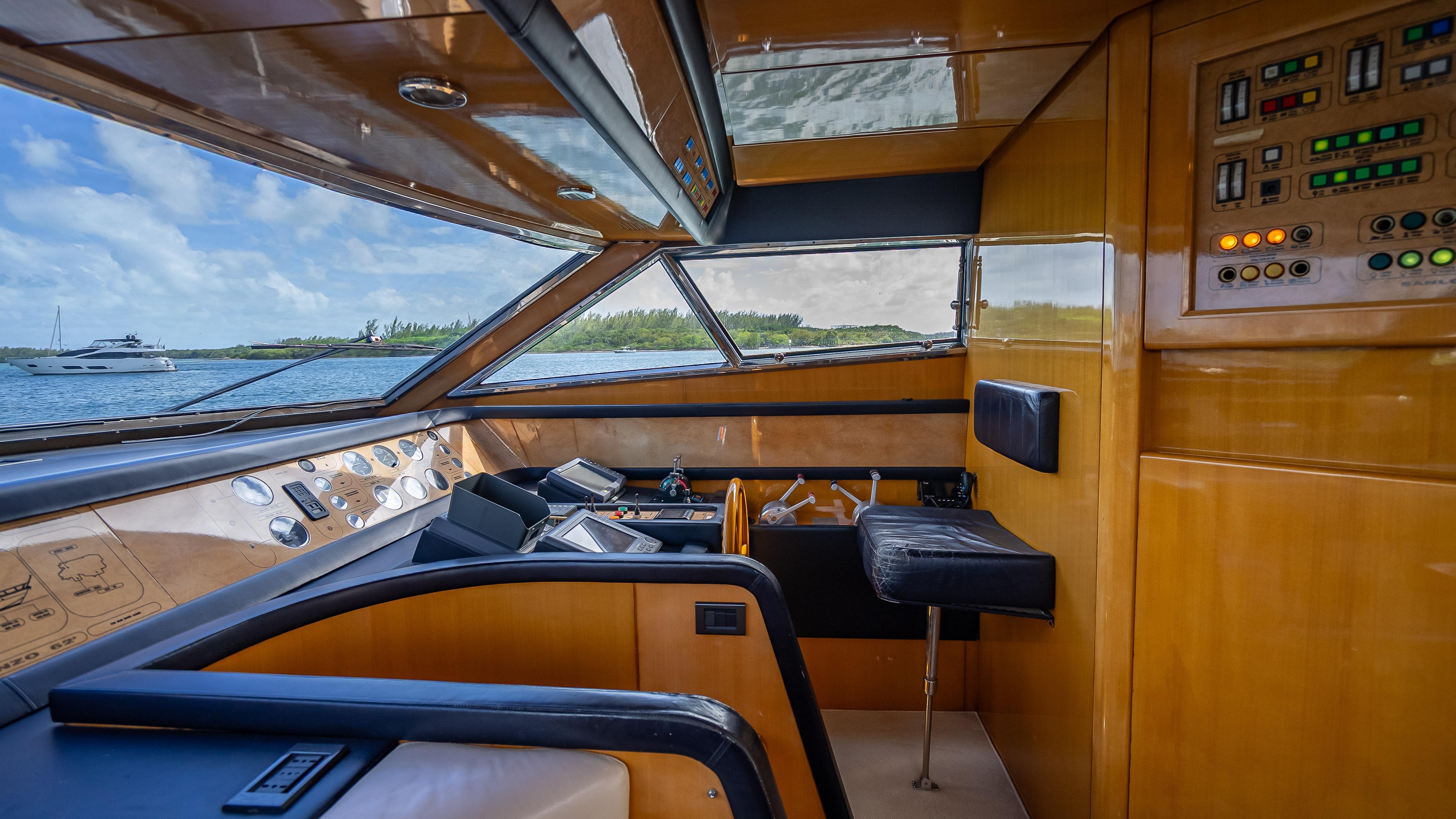 Interior view of 1995 Sanlorenzo 62 yacht cockpit with control panels and seating.