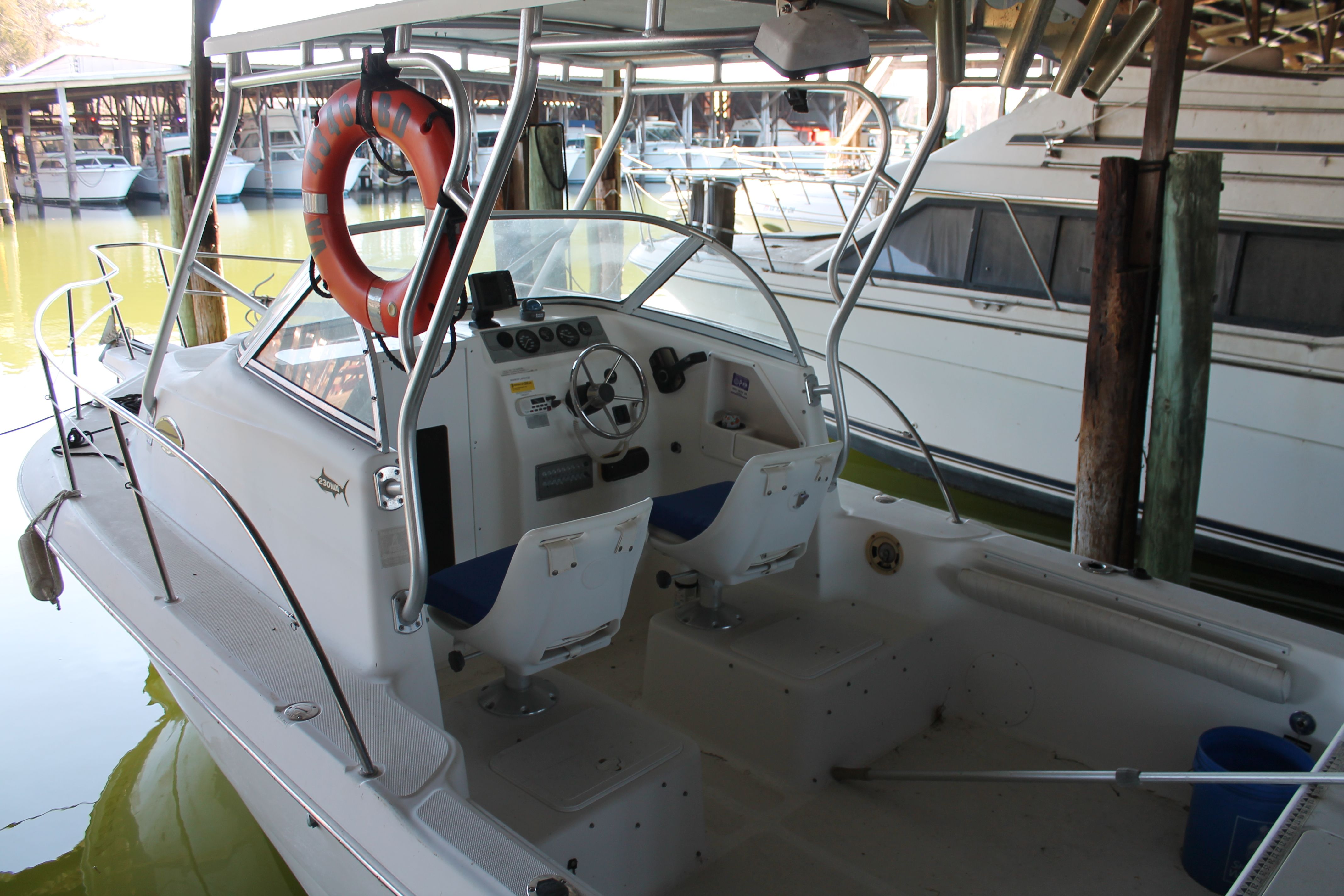 2004 Sea Fox 230 Walk Around boat docked in marina.