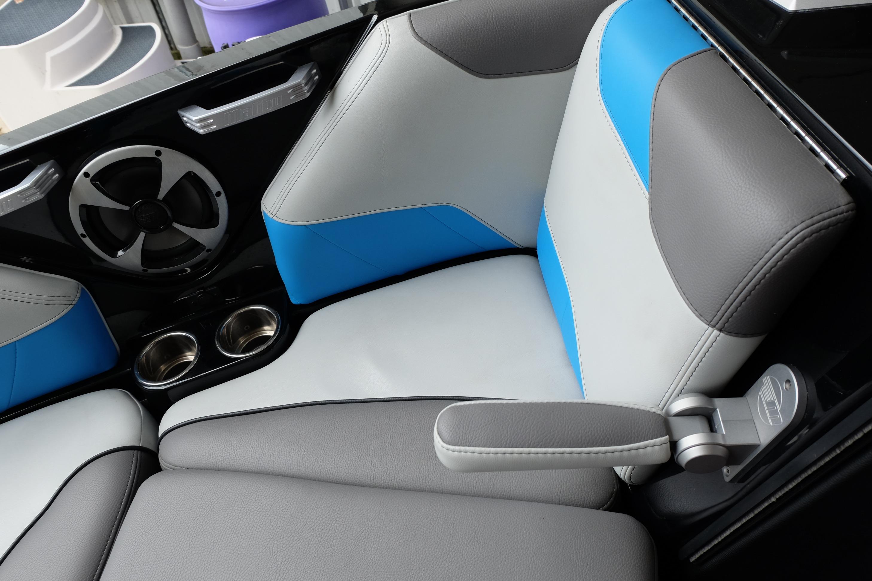 2020 Malibu Wakesetter 23 LSV interior with blue and gray seating, speaker, and cup holders.