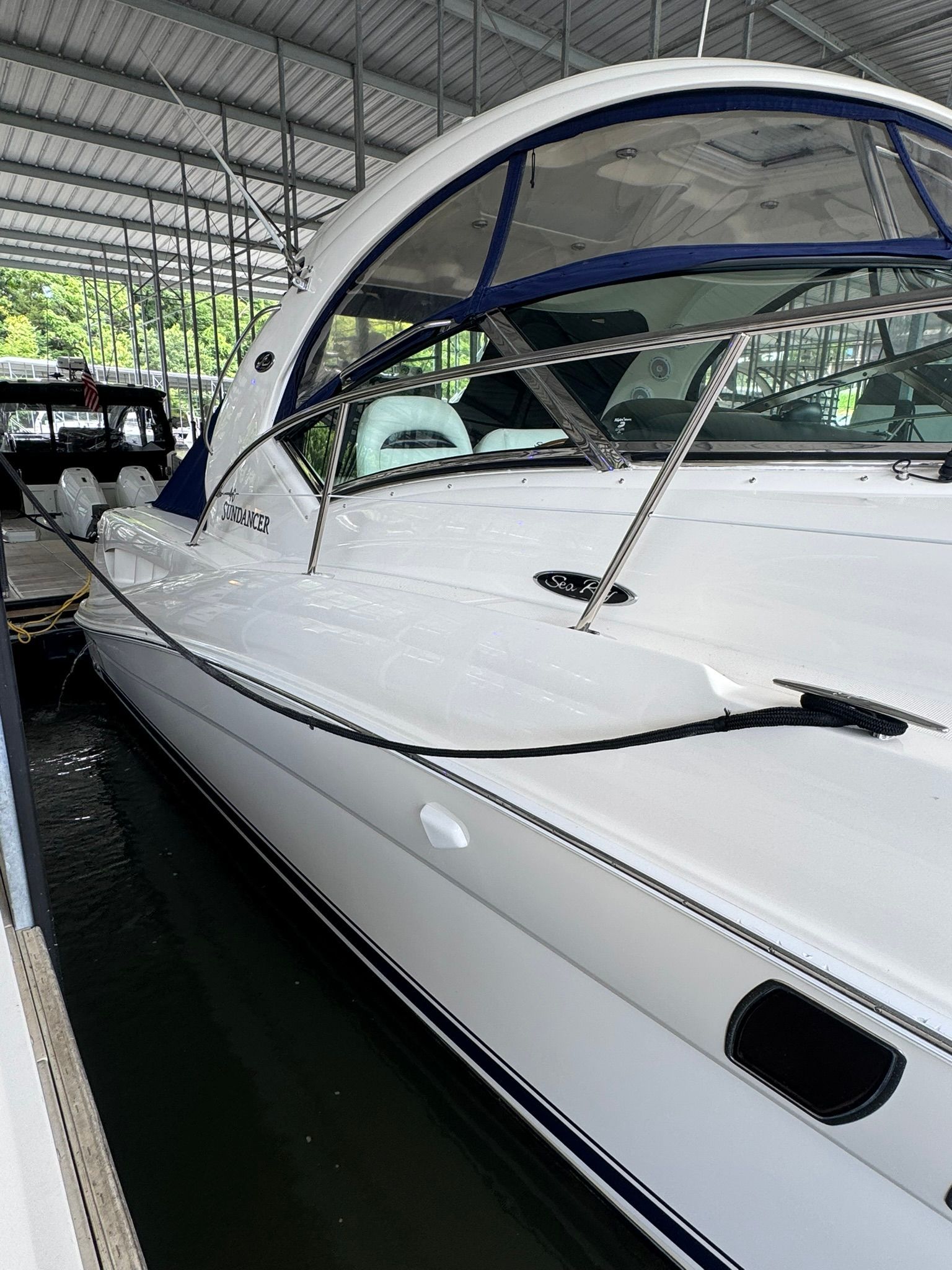 A 2007 Sea Ray 40 Sundancer docked in a covered marina.