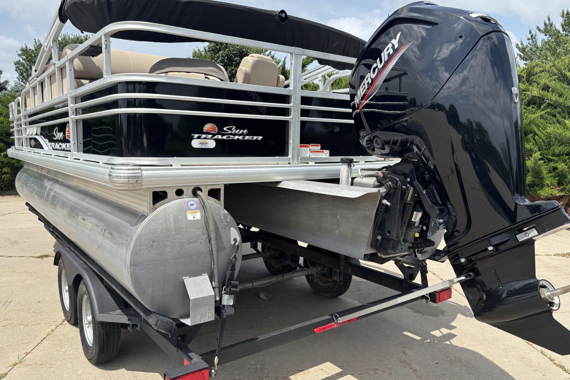 2023 Sun Tracker SportFish 20 DLX pontoon boat with Mercury outboard motor on trailer.