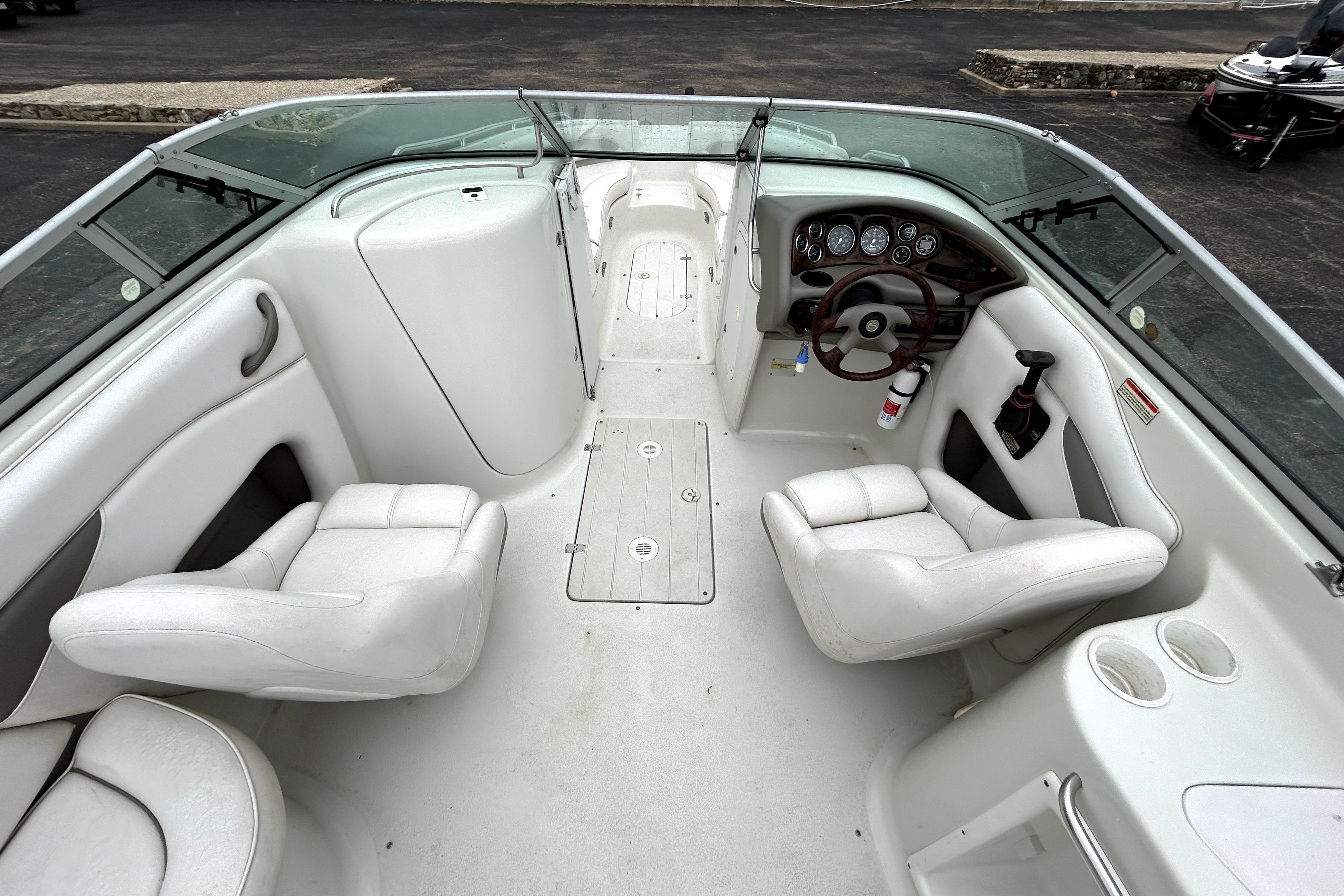 Interior of a 2001 Crownline 239 DB boat with white seating and dashboard.