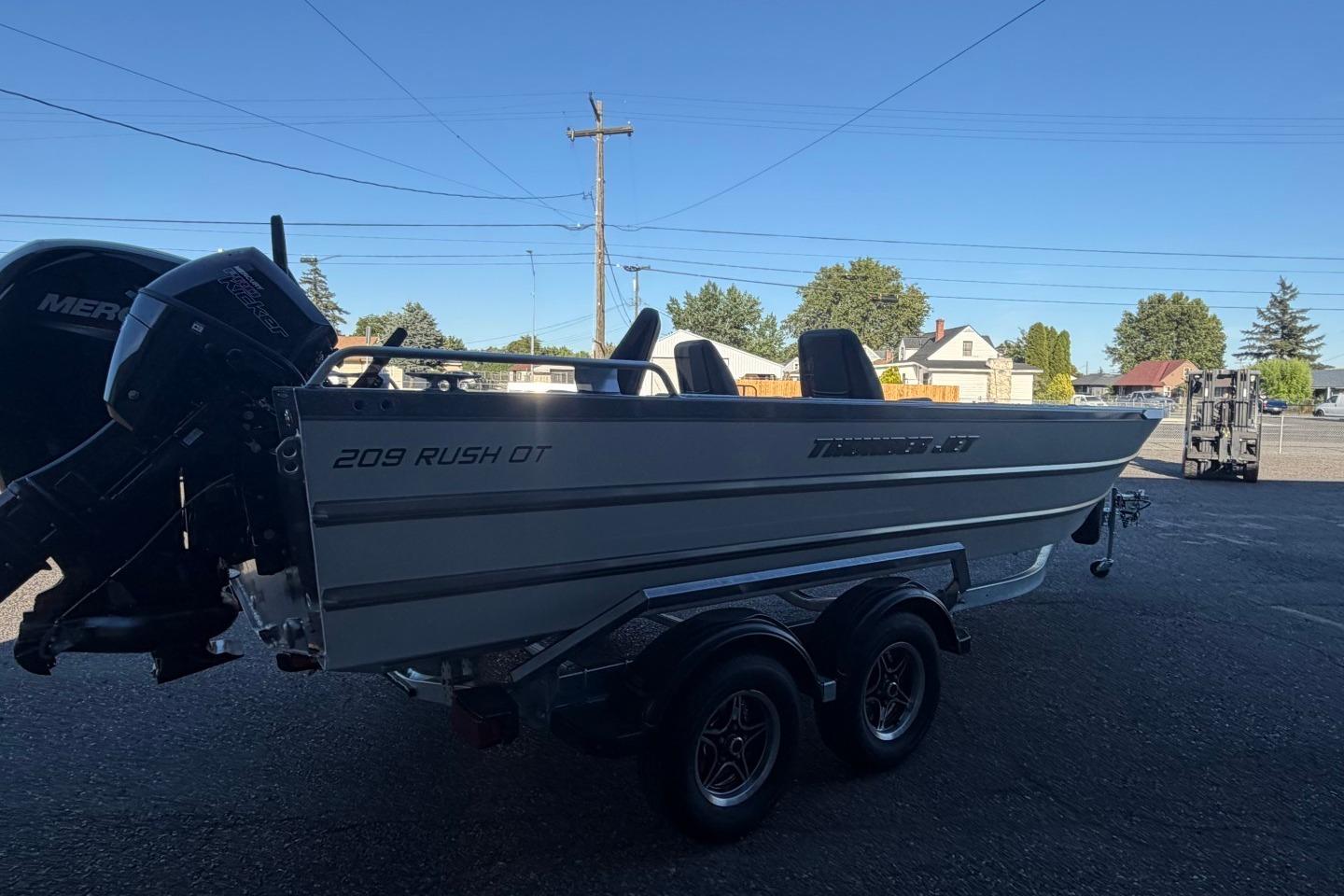 2026 Thunder Jet 209 Rush OT boat on trailer, parked outdoors under clear sky.