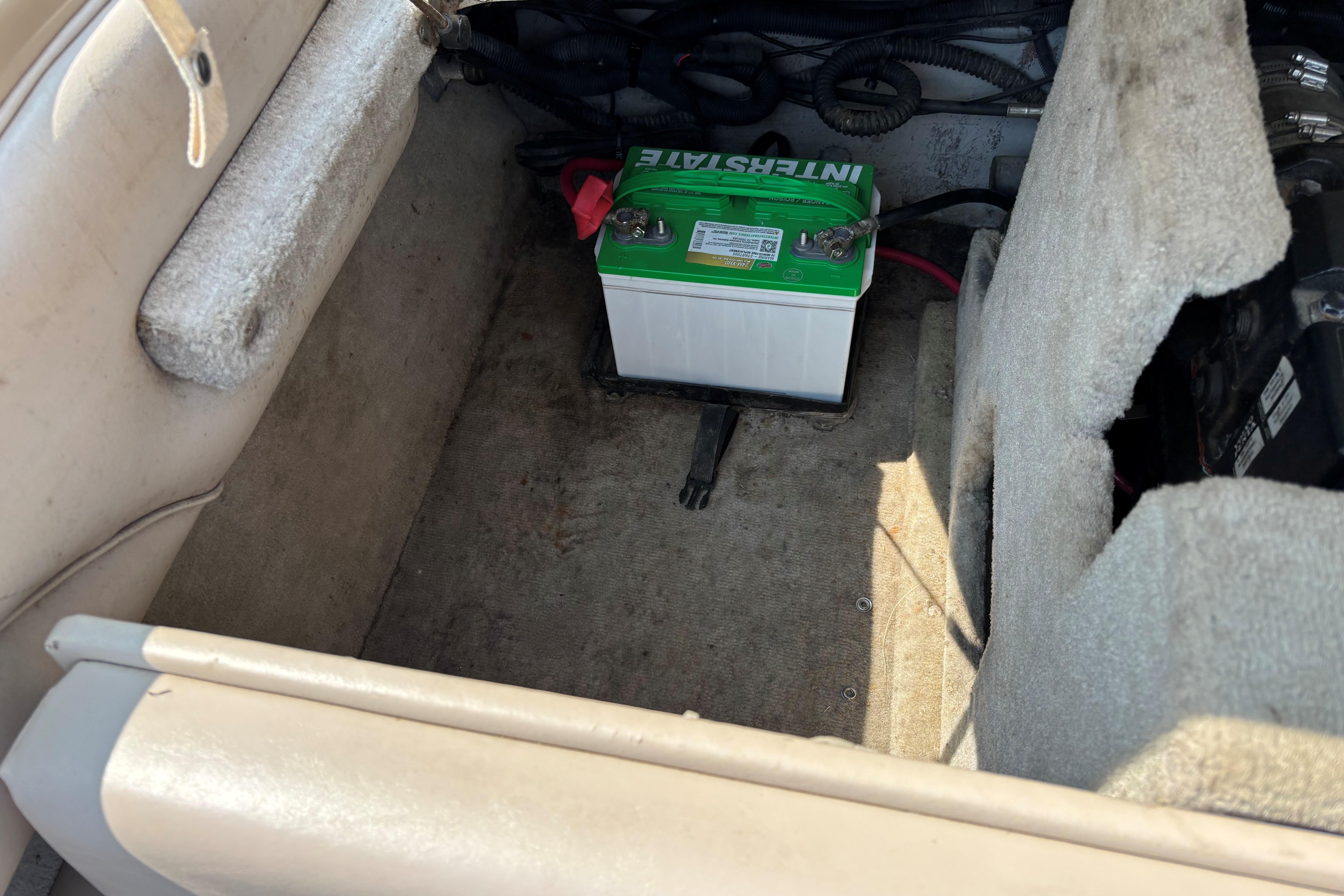 Interior of a 2001 Crownline 18' boat showing a battery compartment.