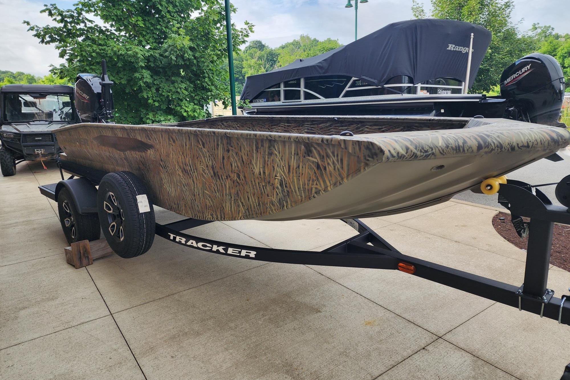 2026 Tracker Grizzly 1650 T Prairie Wings Edition boat on trailer, camo design.