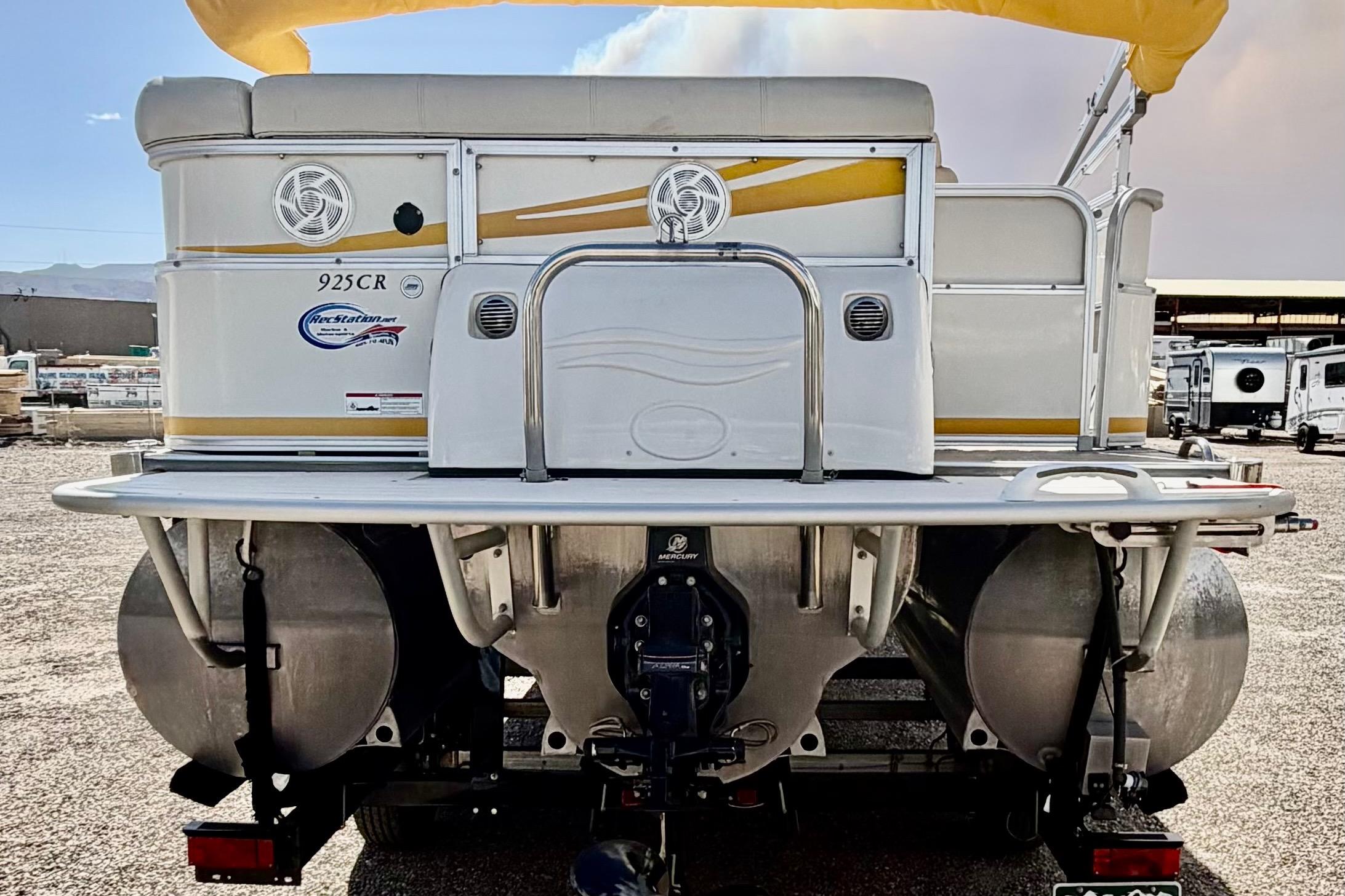 Rear view of a 2006 South Bay 925CR pontoon boat with yellow accents.