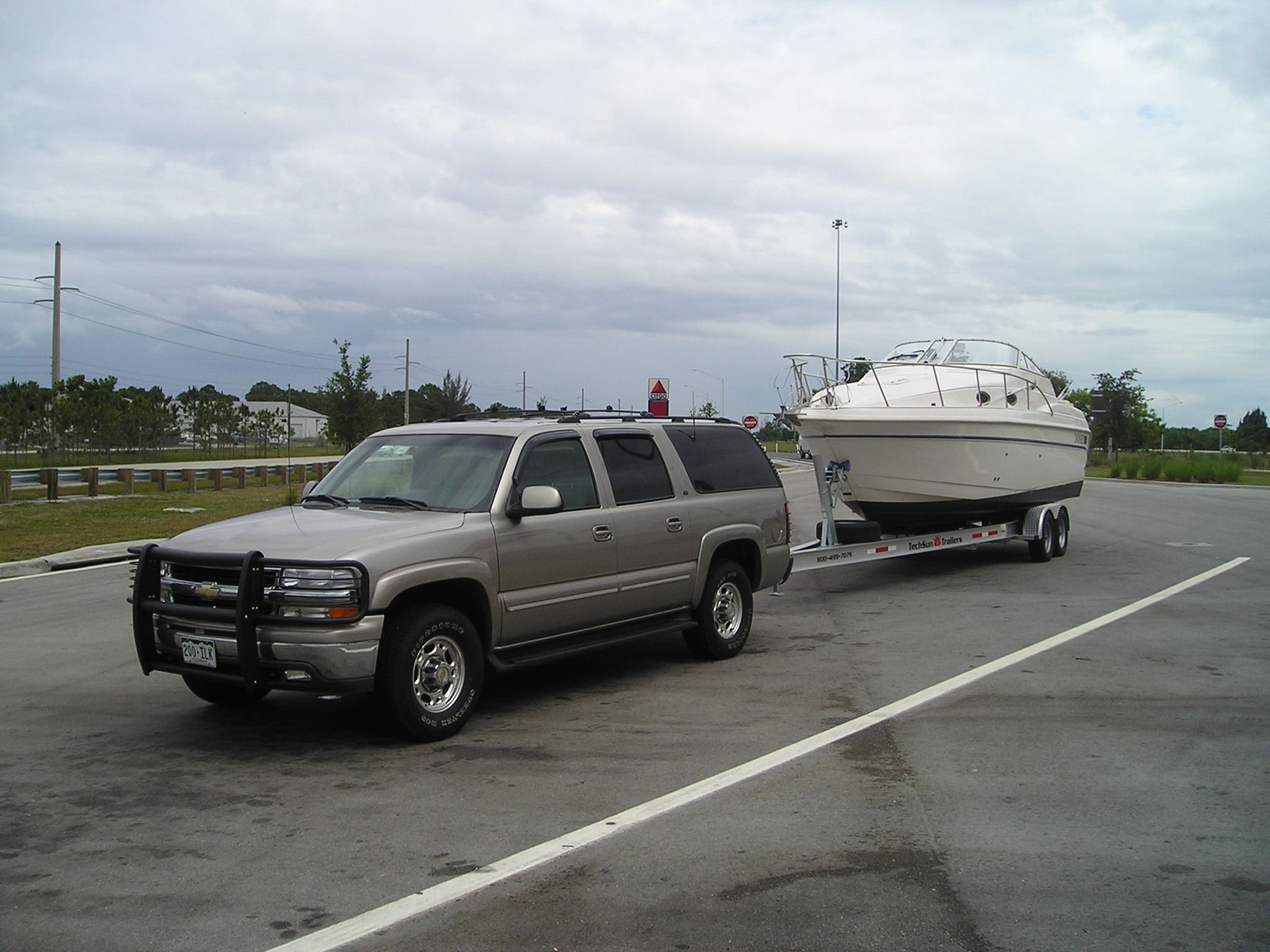 SUV towing 1997 Donzi 275LXC boat on trailer.