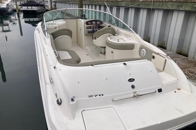 2006 Sea Ray 270 Sundeck boat docked, featuring spacious seating and sleek design.
