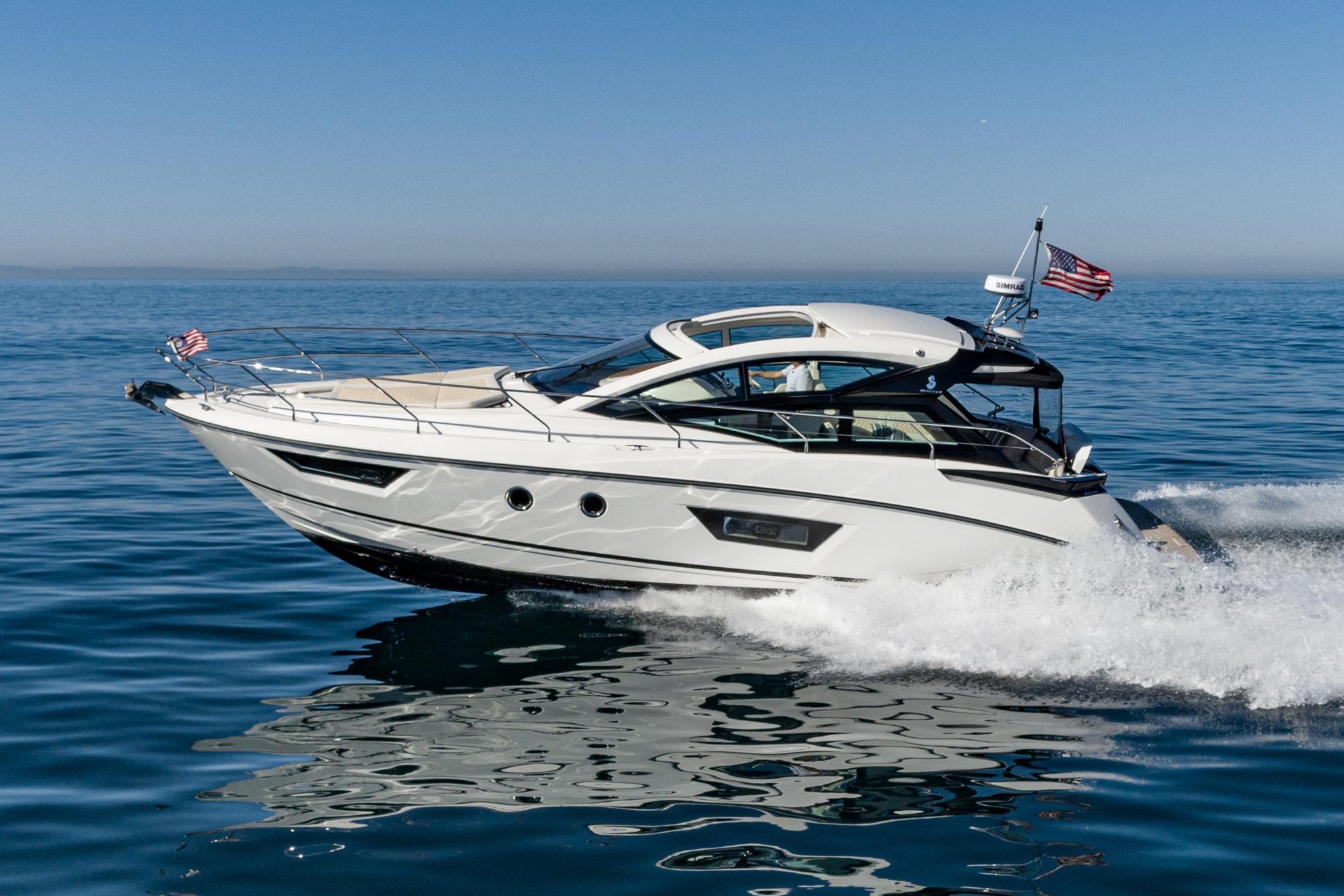 2018 Beneteau Gran Turismo 40 yacht cruising on open water, clear blue sky.